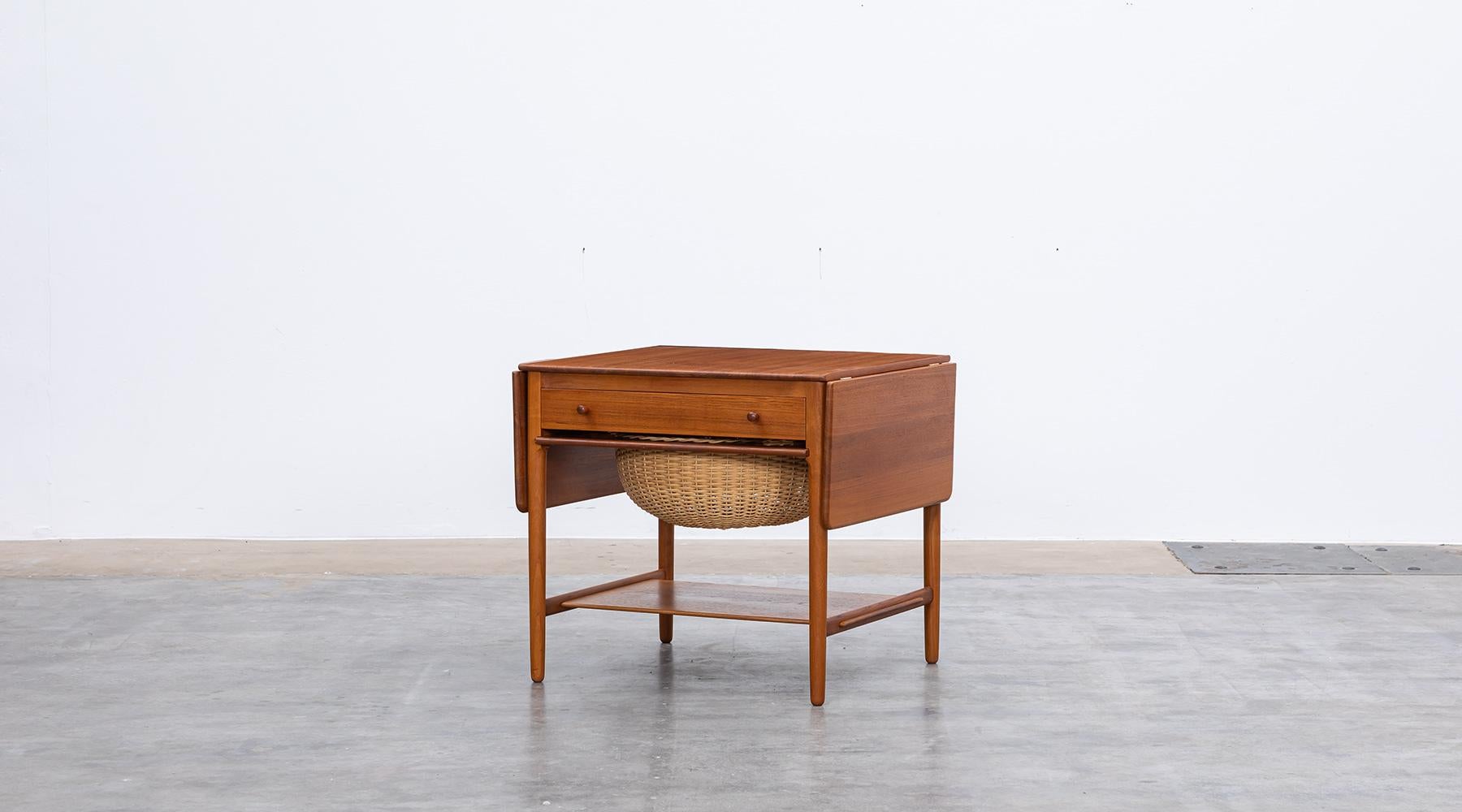 Mid-Century Modern, AT-33, sewing table by Hans J. Wegner for Andreas Tuck, Denmark, 1950s

The sewing table in teak is foldable on both sides. The drawer has a detailed, practical subdivision for storage of small items. The basket under the drawer