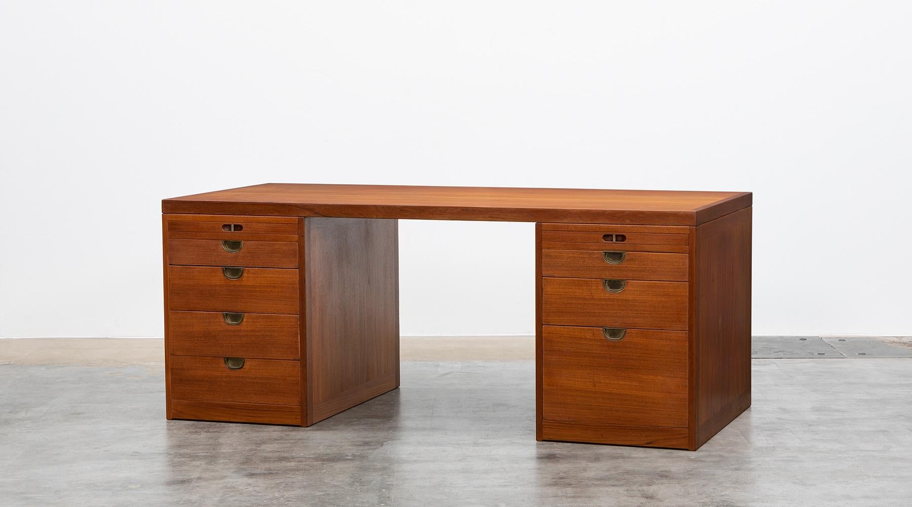 Desk by Børge Mogensen, teak and brass details, Denmark, 1950.

Bold and classic writing desk in teak designed by Borge Mogensen with a slim table top and nine drawers in different sizes for a lot of storage space. The grips are brass, the top is