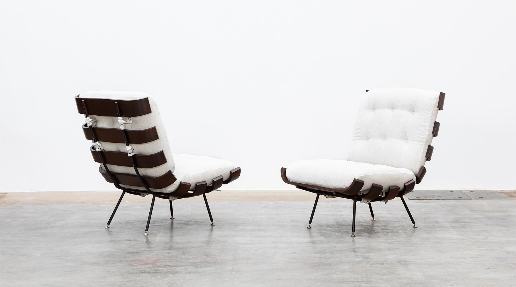 Matching pair of lounge chairs, teak and plywood, Eisler / Hauner, Brazil, 1959.

Wonderful Brazilian lounge chairs designed by Martin Eisler & Carlo Hauner. This pair has been produced in teak and plywood slats bent elegant to the ends and stands