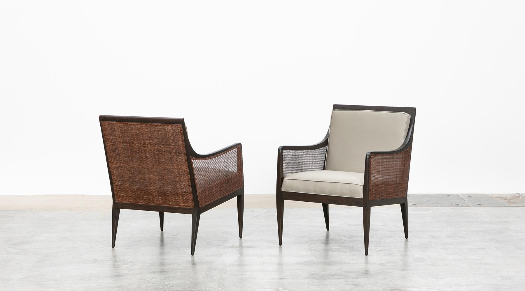 Lounge chairs, walnut and cane, new upholstery, Kipp Stewart, USA, 1950s.

Elegant pair of armchairs in solid walnut with caned back and sides designed by Kipp Stewart. The caning and wood are in excellent condition. The back cushion is removable