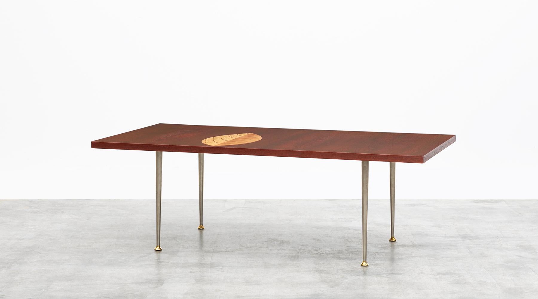 Veneered tabletop, brass base, Tapio Wirkkala for Asko, Finland, 1958.

Fantastic coffee table designed by Tapio Wirkkala in 1958. The veneered tabletop comes with a wooden inlay in leaf ornament on a metal base. Manufactured by Asko.
Similar