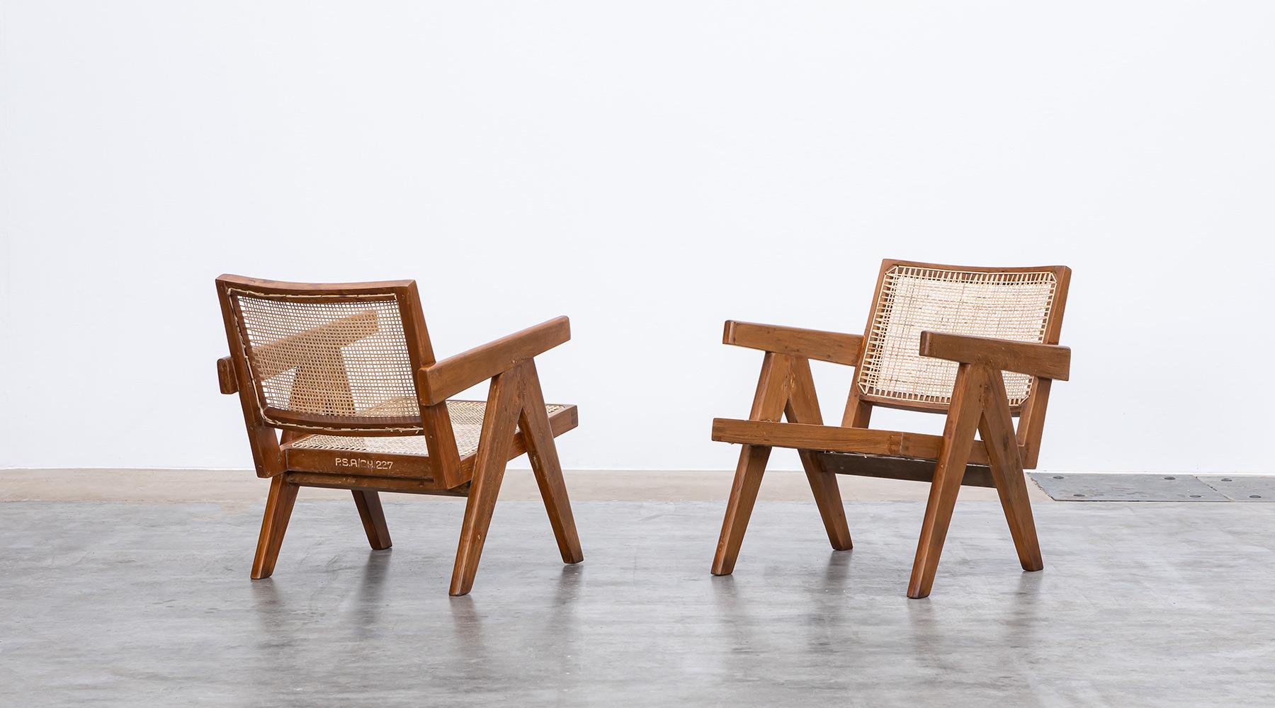 Lounge chairs designed by Pierre Jeanneret in teak and cane, Chandigarh, India, 1955.

These original lounge chairs designed by Pierre Jeanneret in teak with woven cane on the seat and curved backrest appears in beautiful patina. Both chairs have