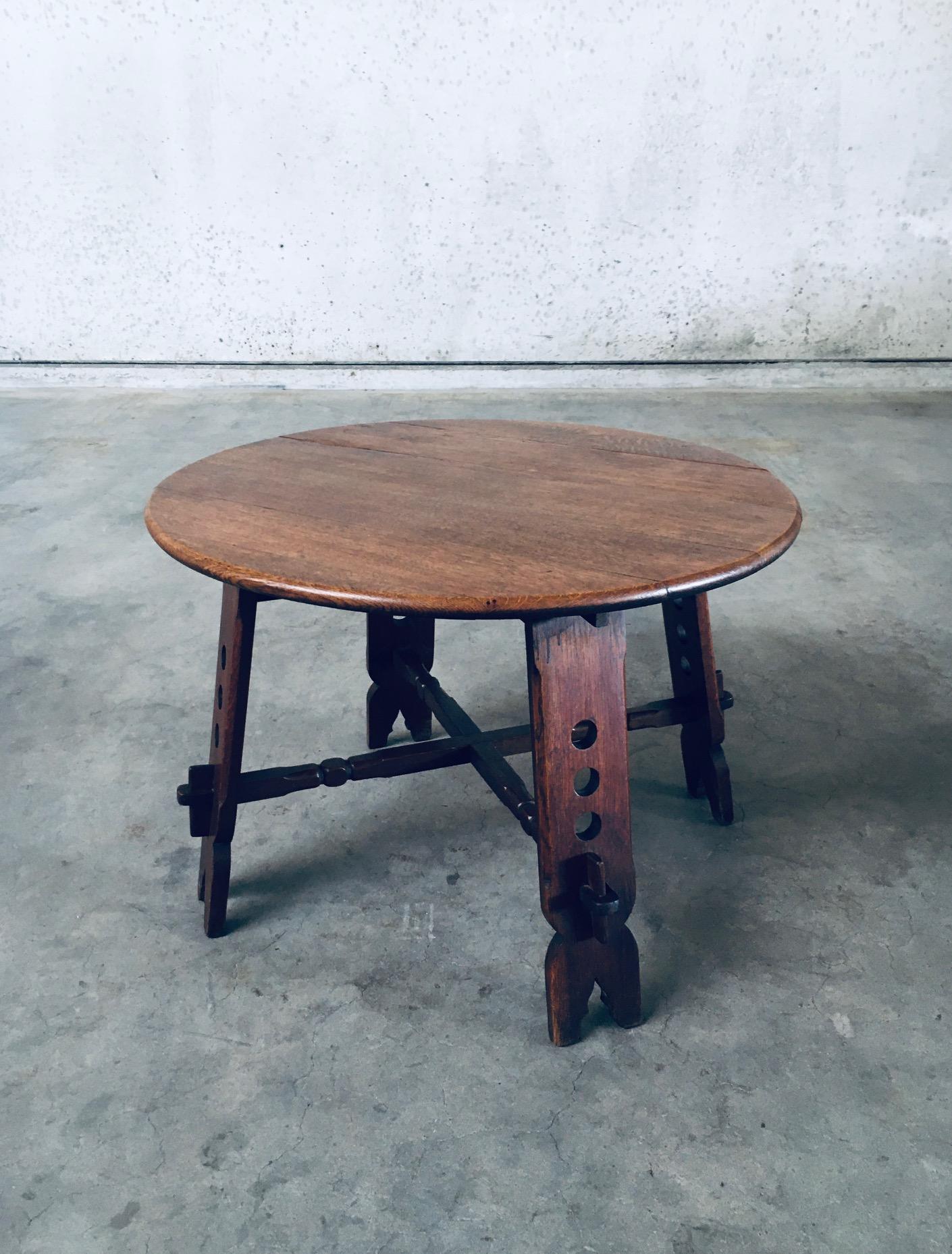 Vintage Brutalist Design Artisan Handmade Carved Side table. Made in Belgium, 1950's period. Solid oak constructed round coffee or side table with carved and turned base set together with wedges. This comes in good all original condition with normal