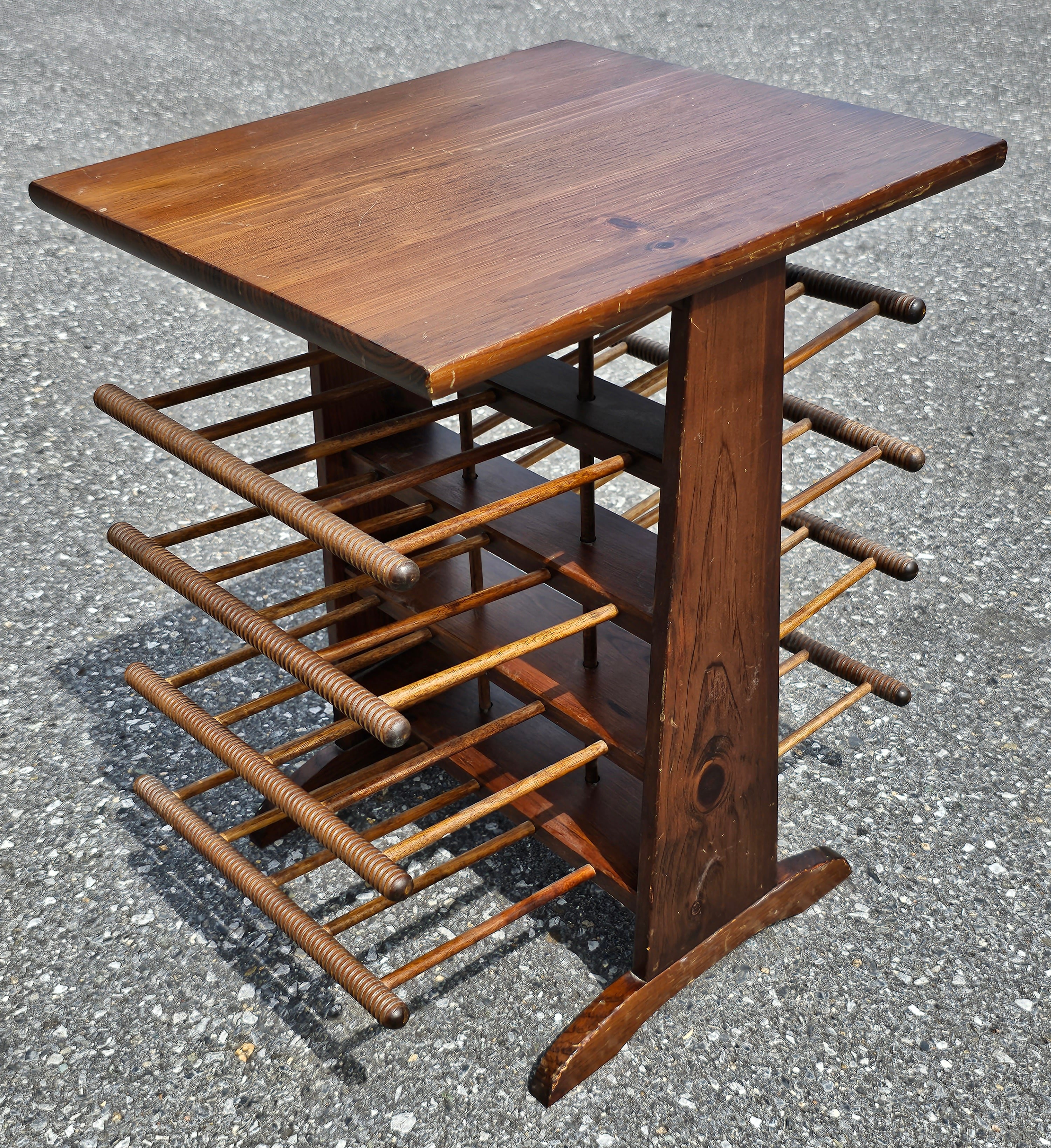 Hand made and utilizing turned bobbin style ends, this charming little piece is executed in pine and most likely dates from the 1950s. The tabletop is an added bonus as it serves double-duty. Dimensions: 16