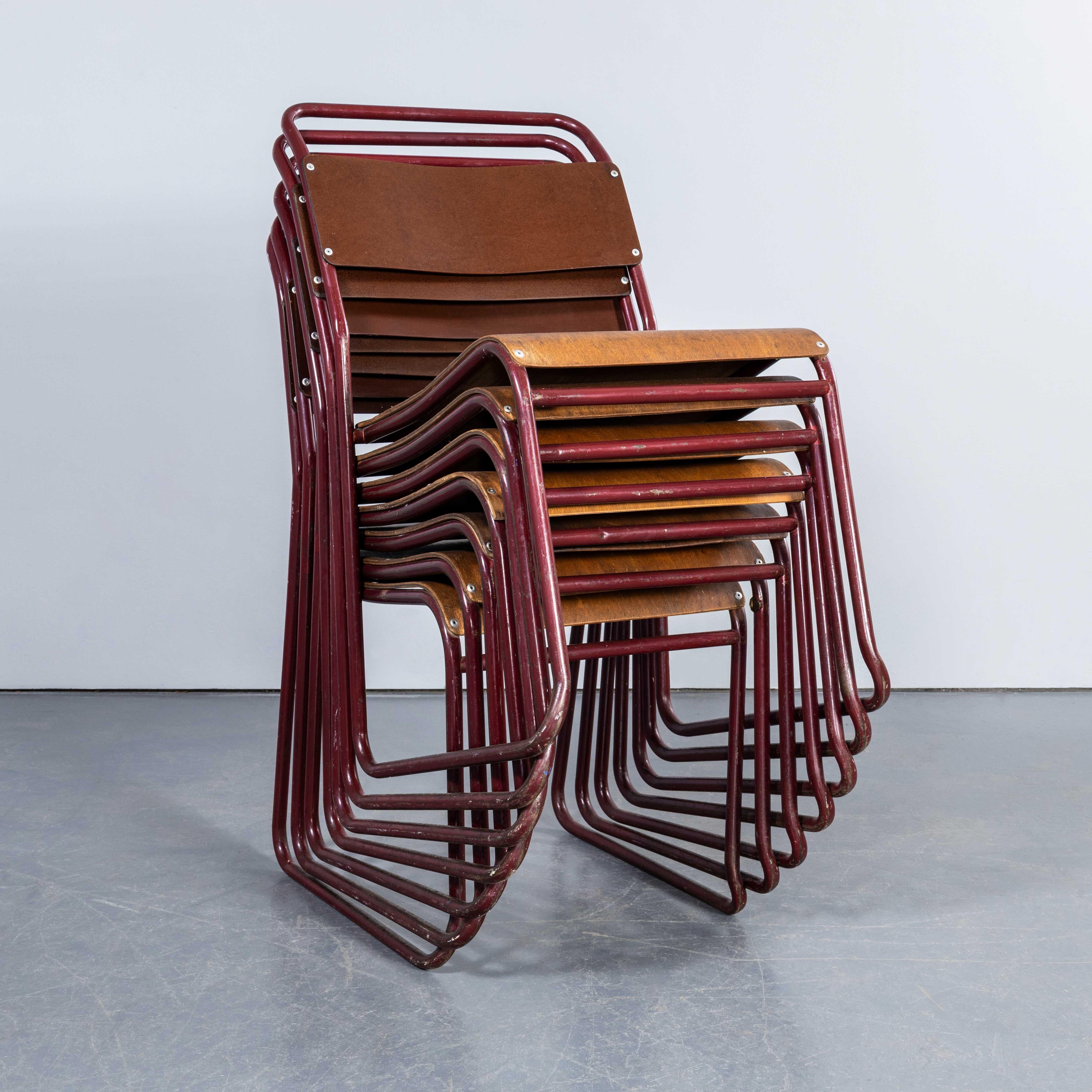1950's Burgundy Tubular Metal Dining Chairs Sebel - Set Of Seven. 
Sebel was one of several manufacturers who made this ubiquitous Bauhaus inspired chair. Sebel manufactured in London and Nest A Bye was the brand trademark that they marketed. Our