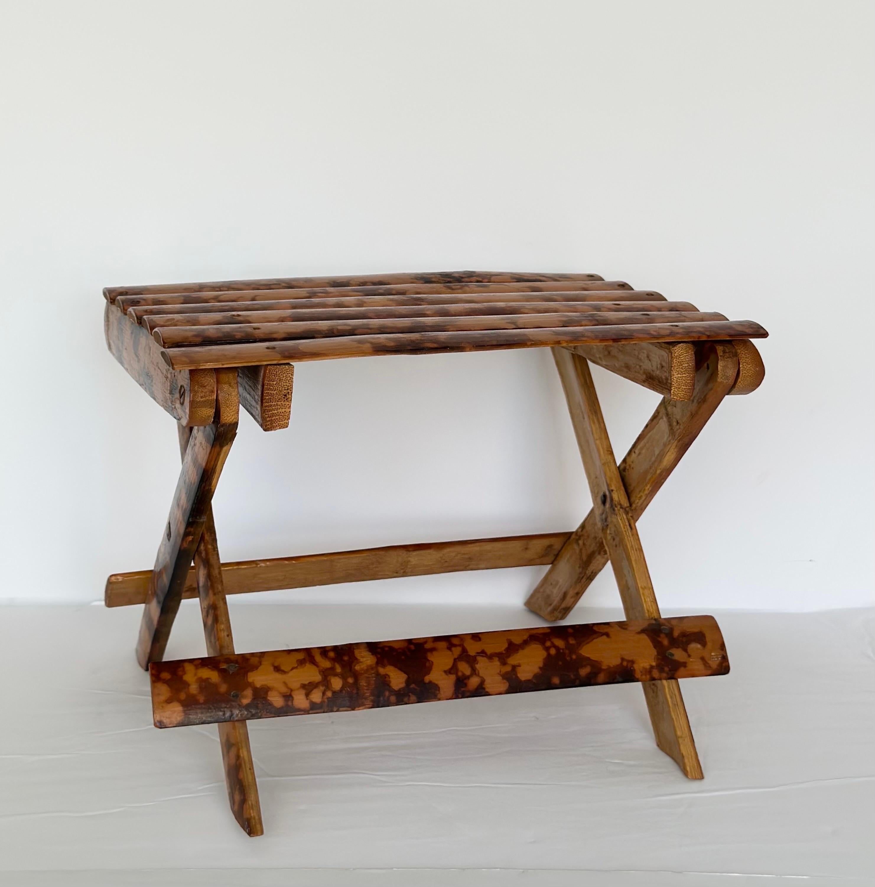 We are very pleased to offer a stunning stool, circa the 1950s.  This piece is crafted from bamboo, a lightweight and sustainable material, its appeal is enhanced by a burnt tortoise finish, giving it a distinct look. The burned bamboo exudes warmth