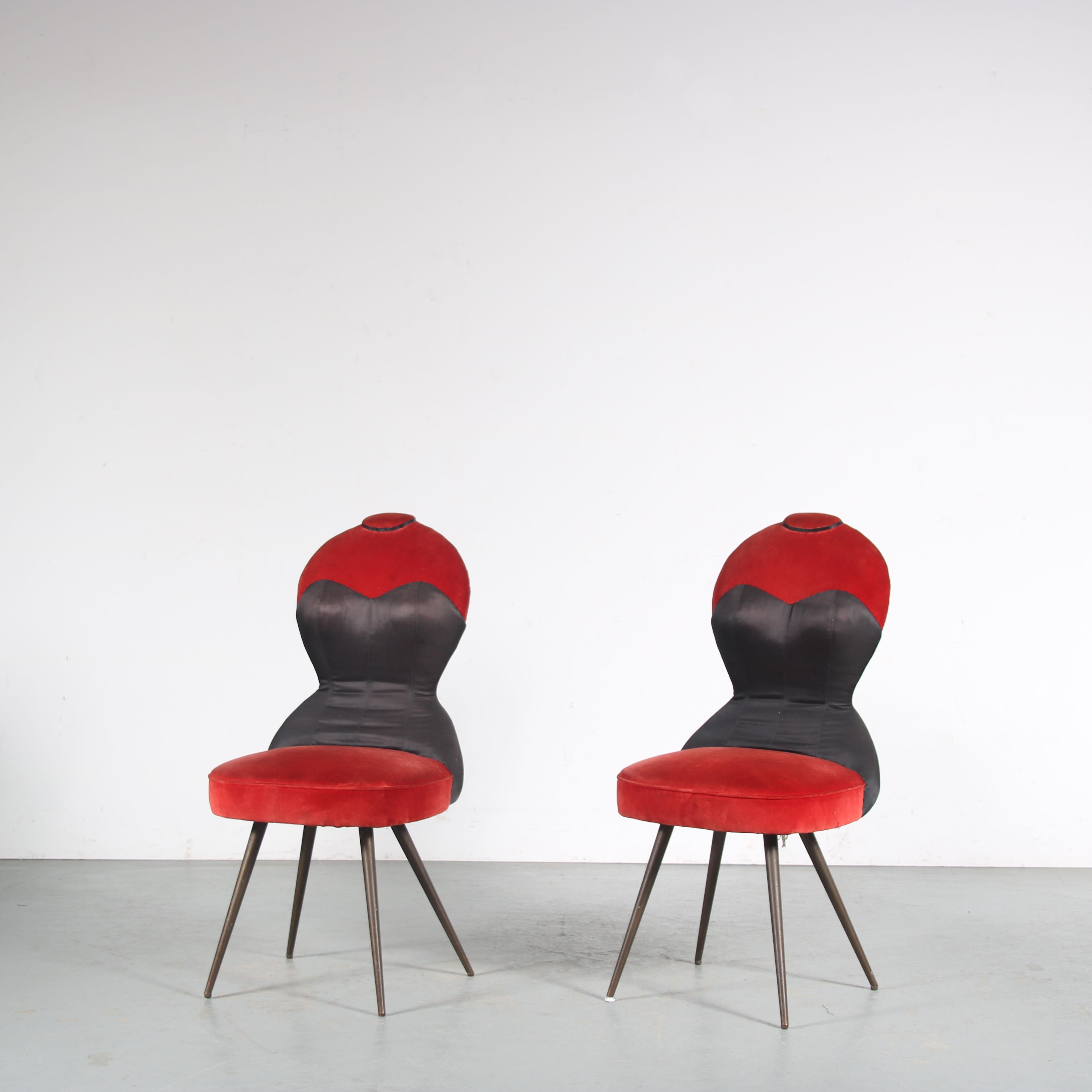 A unique set of two side chairs, manufactured in France around 1950.

These eye-catching, quality chairs have a very unique style and are impressively well made. Upholstered in high quality red velvet with black skai and brass, tapered legs. The