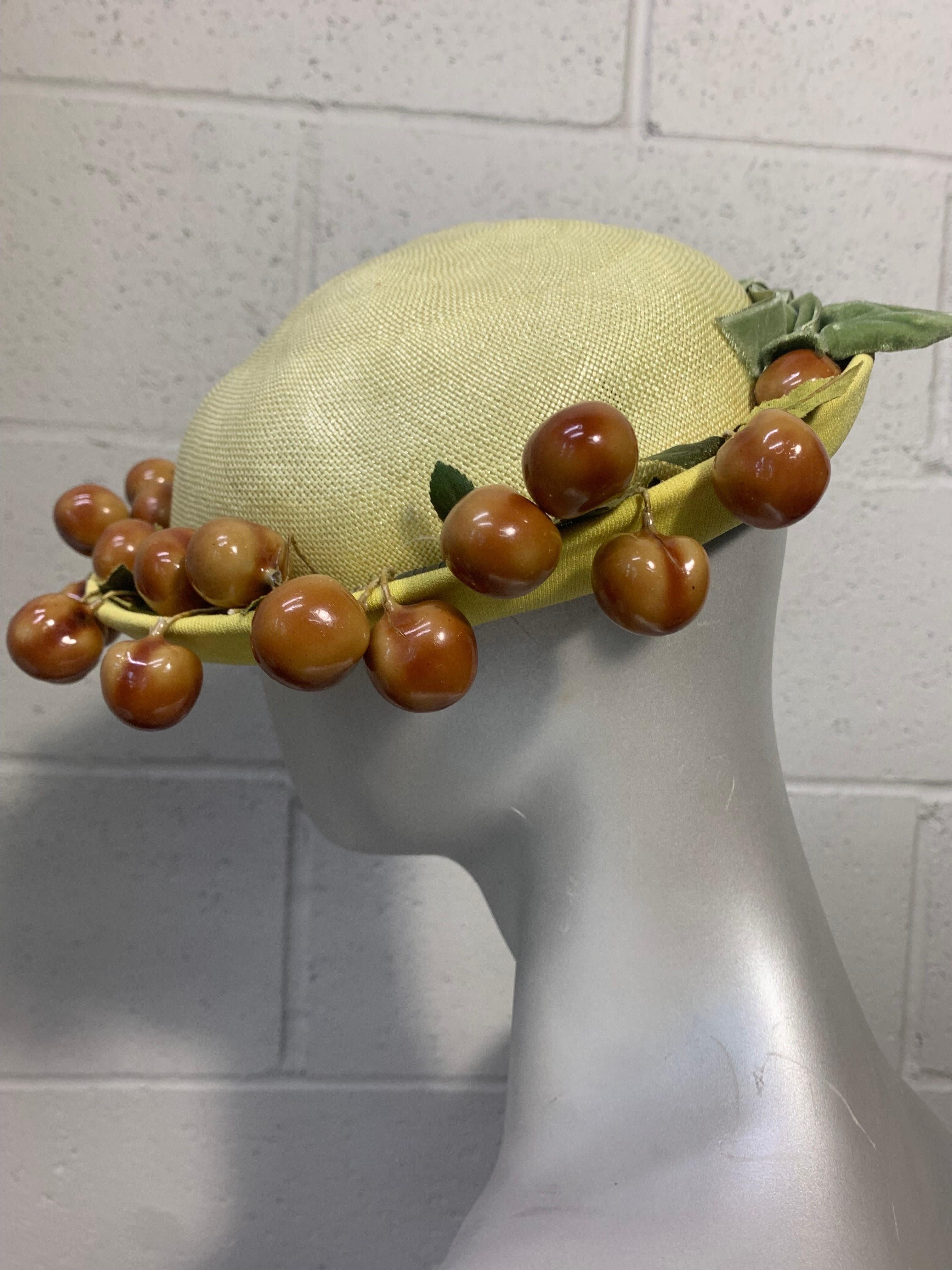 1950s Butter Yellow Breton Straw and Jersey Hat w Whimsical Cherry Garland:  Short-brimmed spring/summer style in a tightly woven straw with a jersey covered brim. Olive green velvet bow at center back. Size 22. Pristine Condition. 