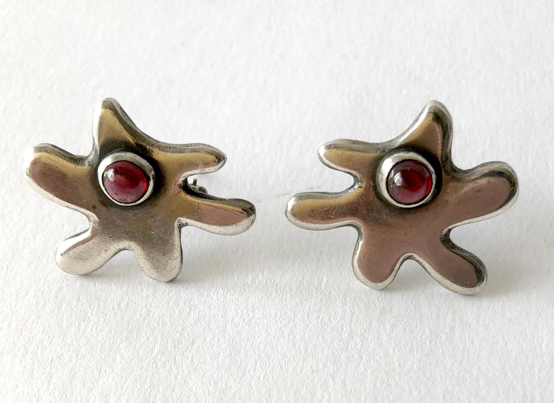 A pair of 1950's sterling silver and garnet amorphic scatter pins created by Byron. Pins measure 1 1/8