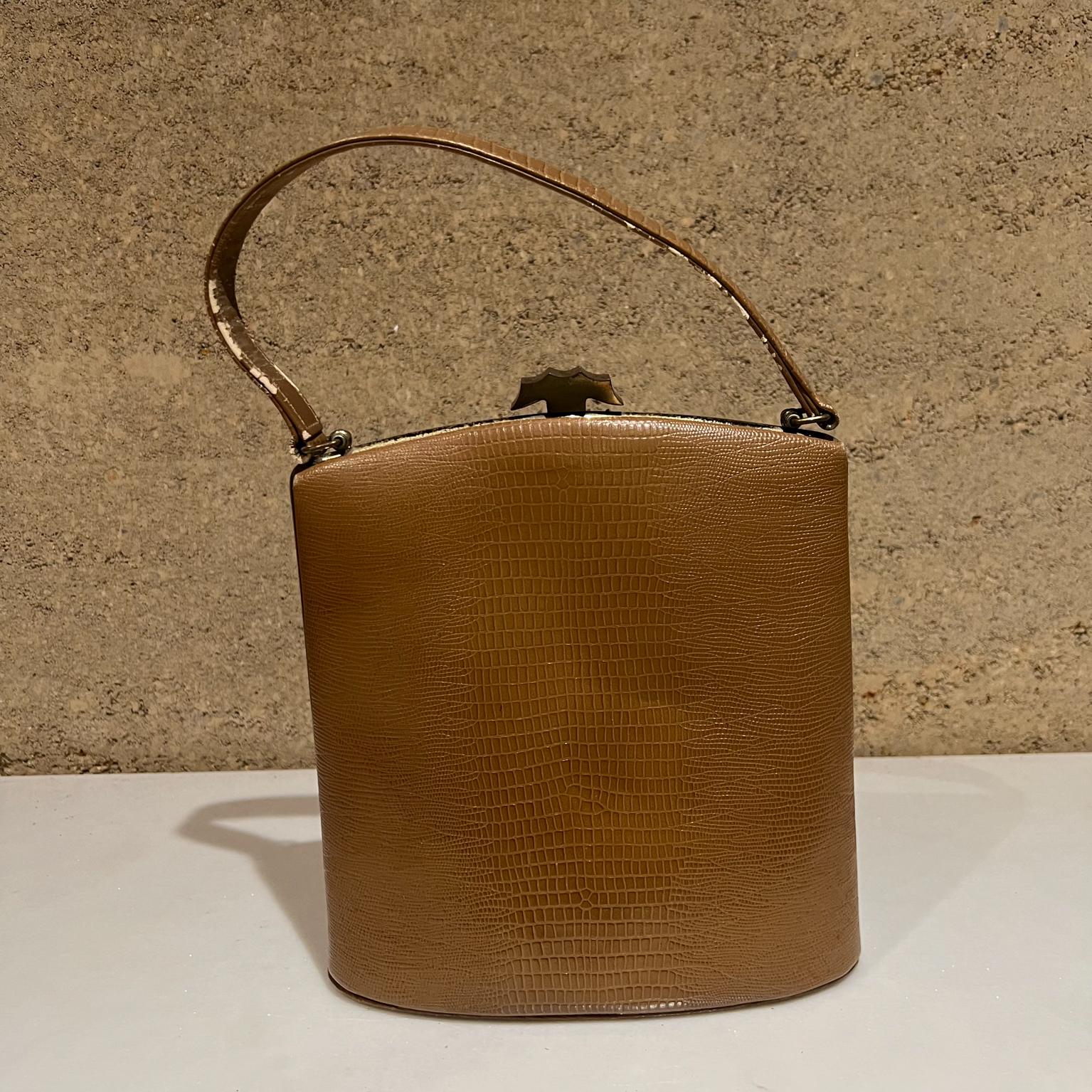 1950s California Vintage Ladies Kelly Handbag Purse May Co Original in Tan Croc with Metal Trim
14.5 tall x 8.5 tall x 3.5 d
Preowned vintage used condition. Blemishes present. Wear is visible.
Review all images.

 