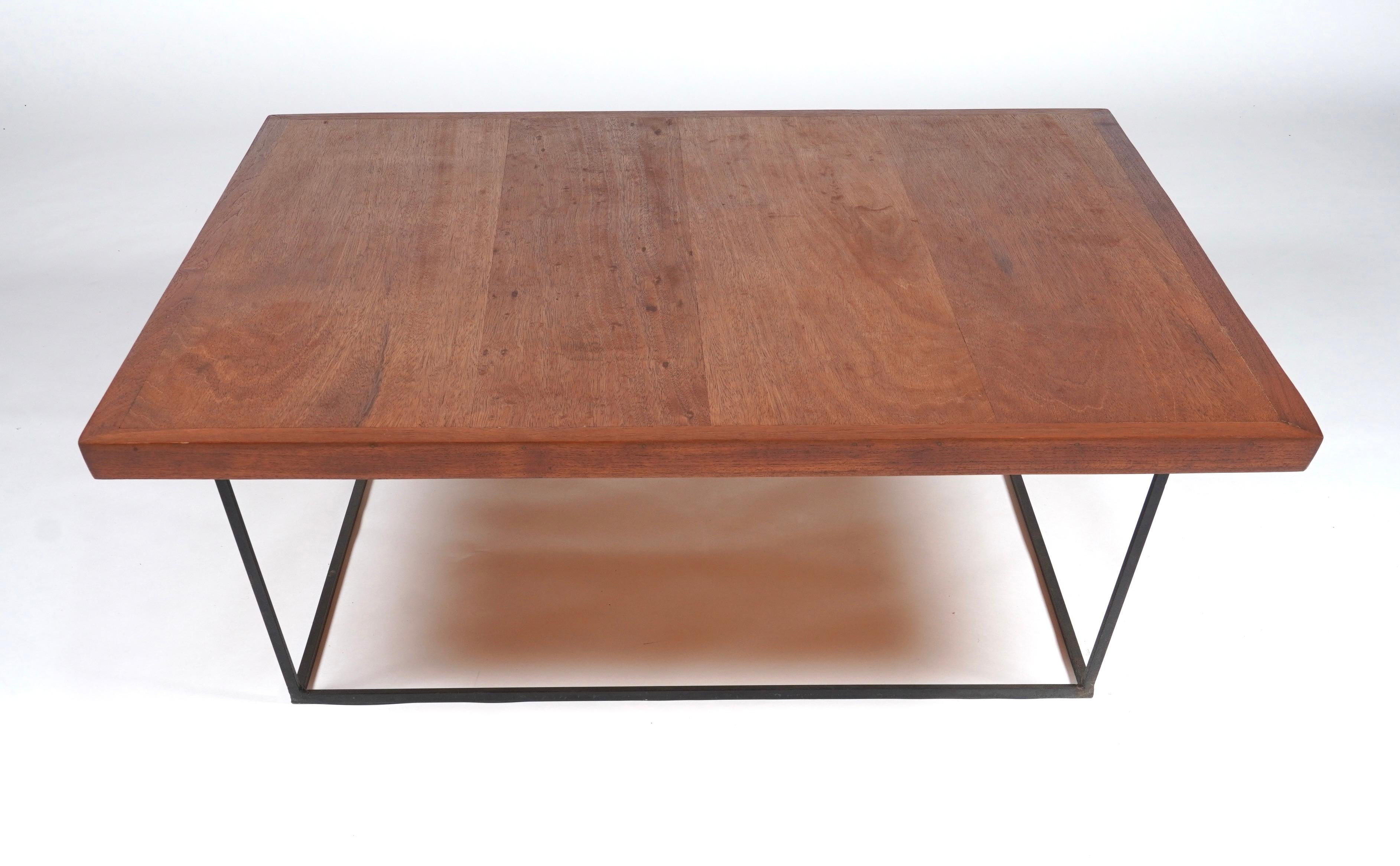 Large scale modernist coffee table crafted in Philippine Mahogany with a wrought iron base. Solid wood trim edging for contrast. The construction is similar to that of Bay Area designer Luther Conover.