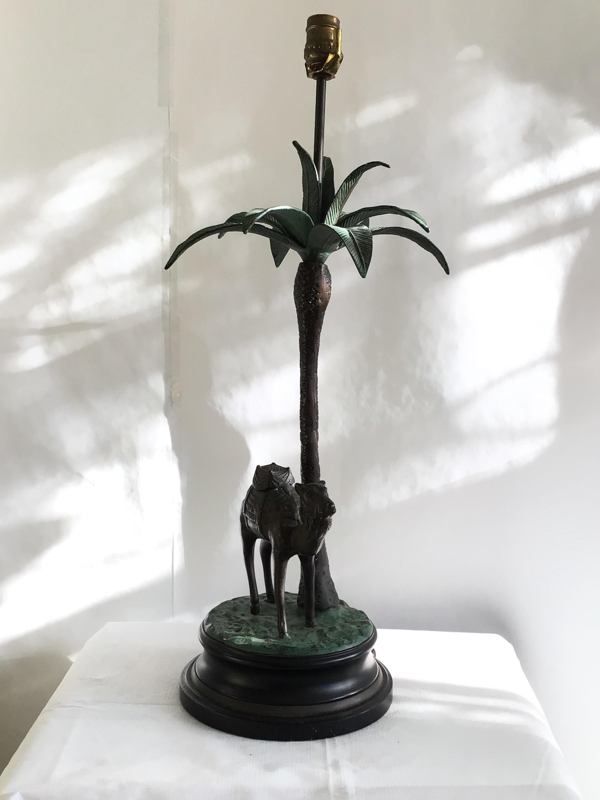 1950s Camel & Palm Trees Decorative Table Lamp on Wood and Metal Base
Classically posed under a palm tree nicely scaled in heavy old cast brass
Some of the leaves and bottom of base are painted
Height is to top of socket
Needs rewiring.