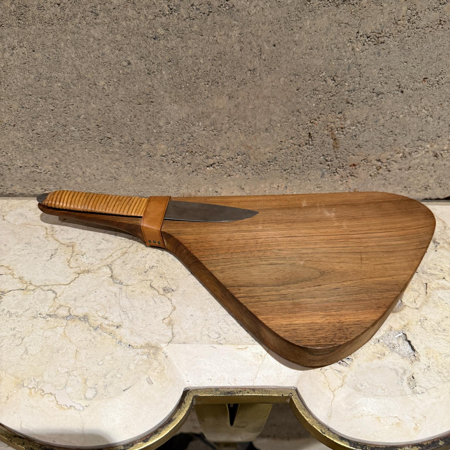 1950s Fantastic design by Austrian designer Carl Auböck
Sculptural walnut wood cutting board. Leather with beautiful patina.
Knife appears as stainless steel (unmarked) with cane wrapped handle.
No stamp present. Patina present. Original unrestored