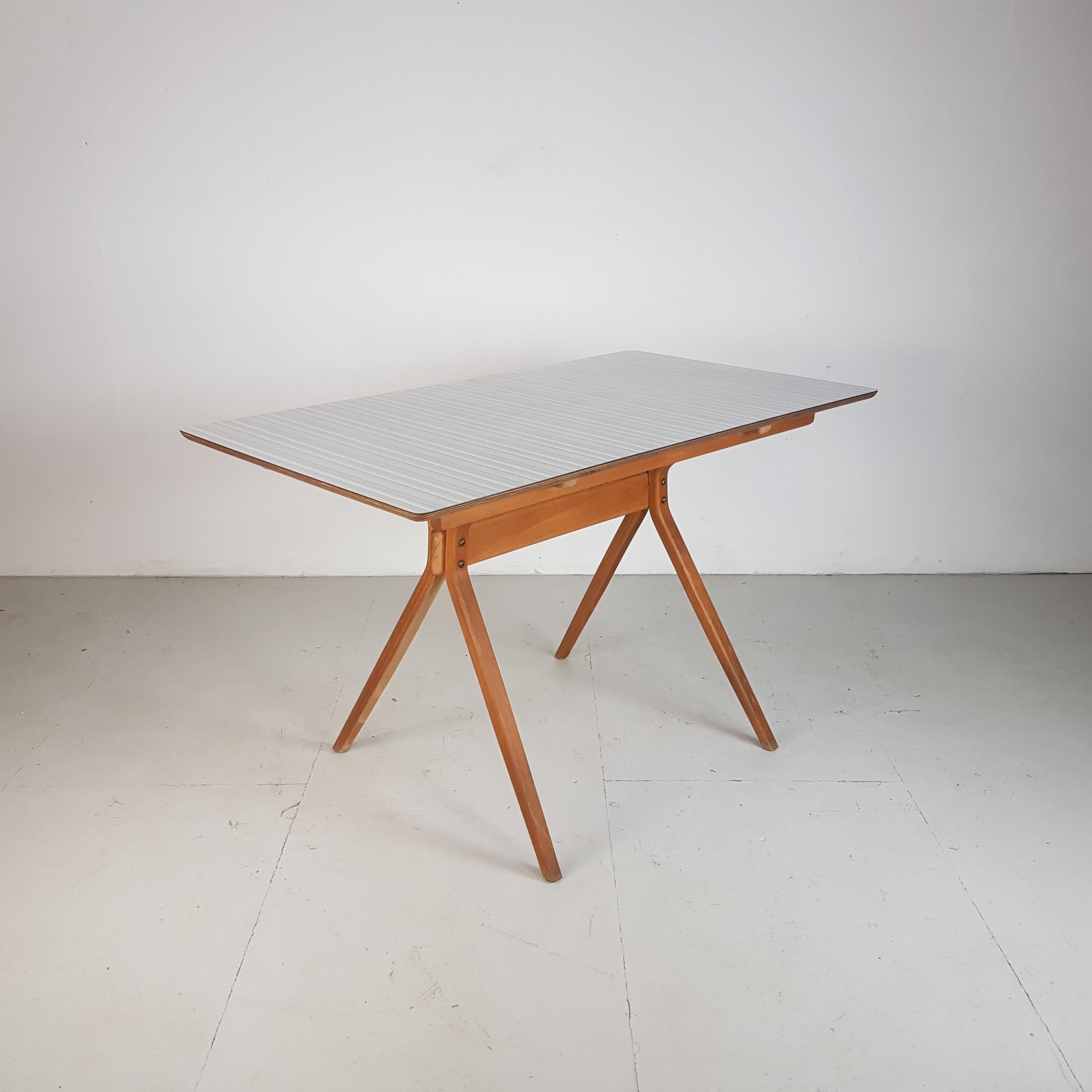 Lovely rectangular table with grey striped formica top made in the 1950s by Kandya. Nice in a kitchen, or would make a great desk.

Beech ply frame and legs.

Approximate dimensions:

Width 122cm

Depth 68cm

Height 74cm

In an overall
