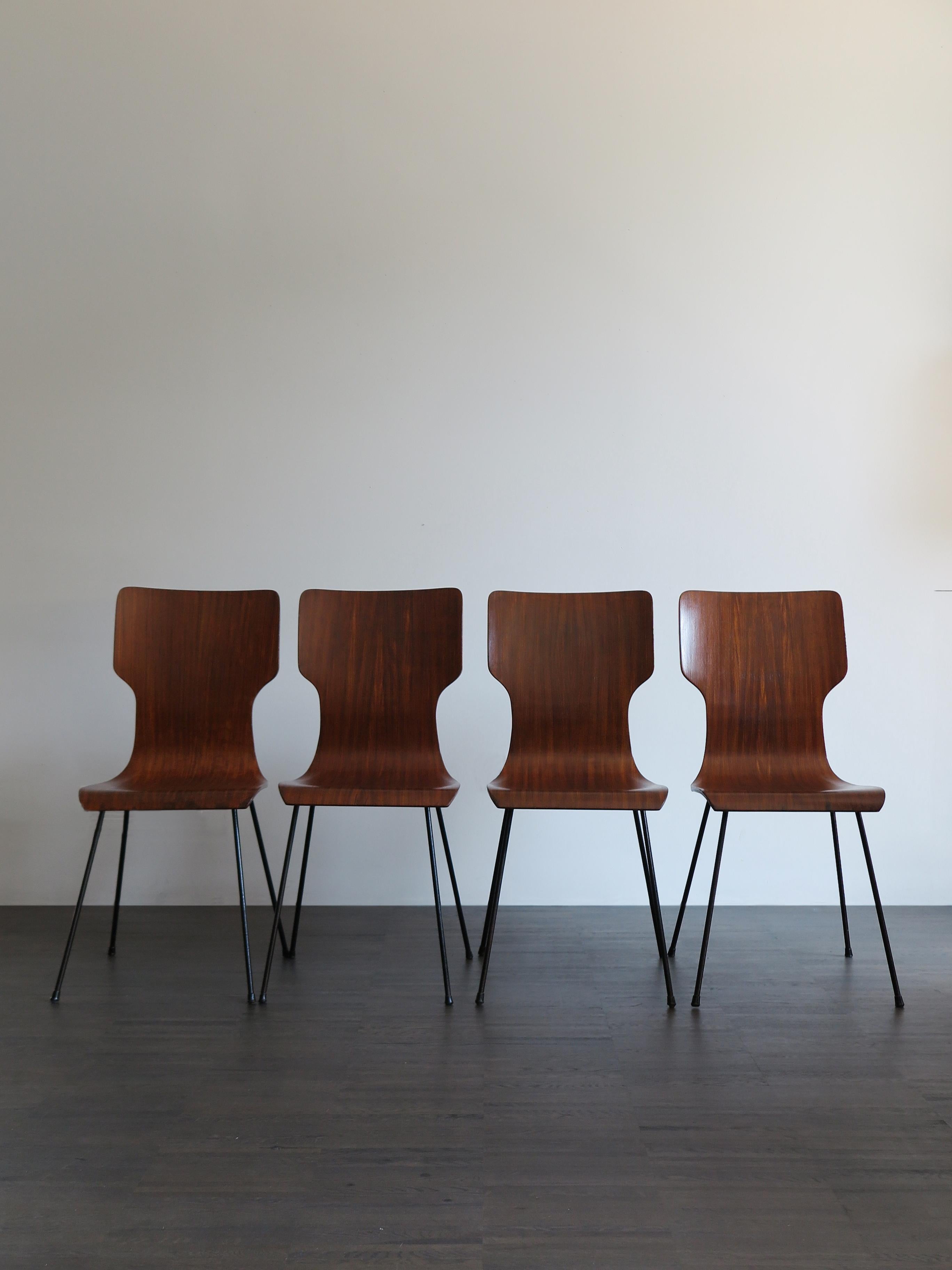 Italian midcentury modern dining chairs designed by Carlo Ratti with black painted metal structure and hot curved plywood shell.
Some signs due to normal use over time.
