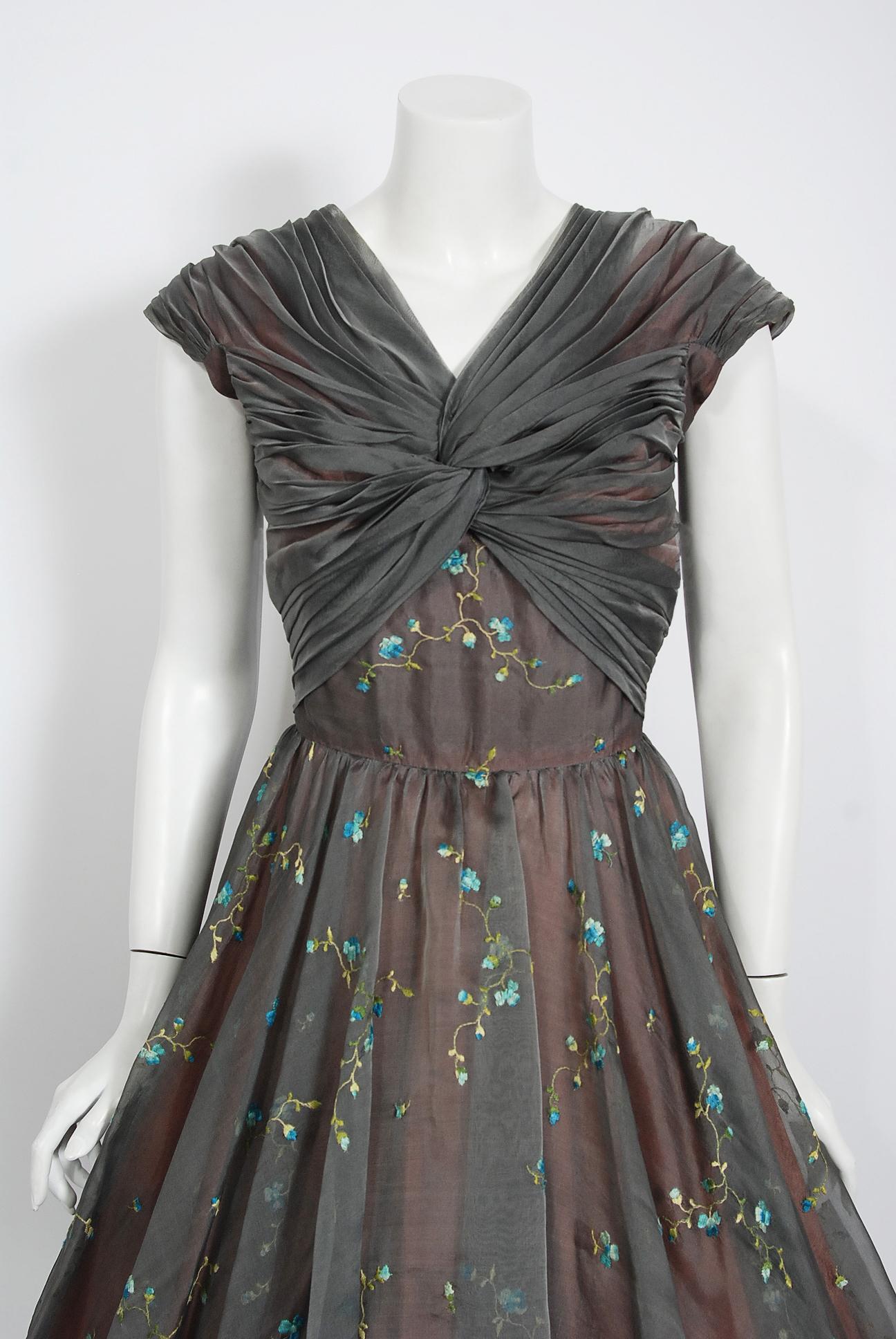 Fashioned from charcoal-gray light weight silk-organza, this 1950's Carlye designer creation has that classic elegance I find irresistible. The bodice has a gorgeous ruched criss-cross design with cap-sleeves. I adore the embroidered floral detail