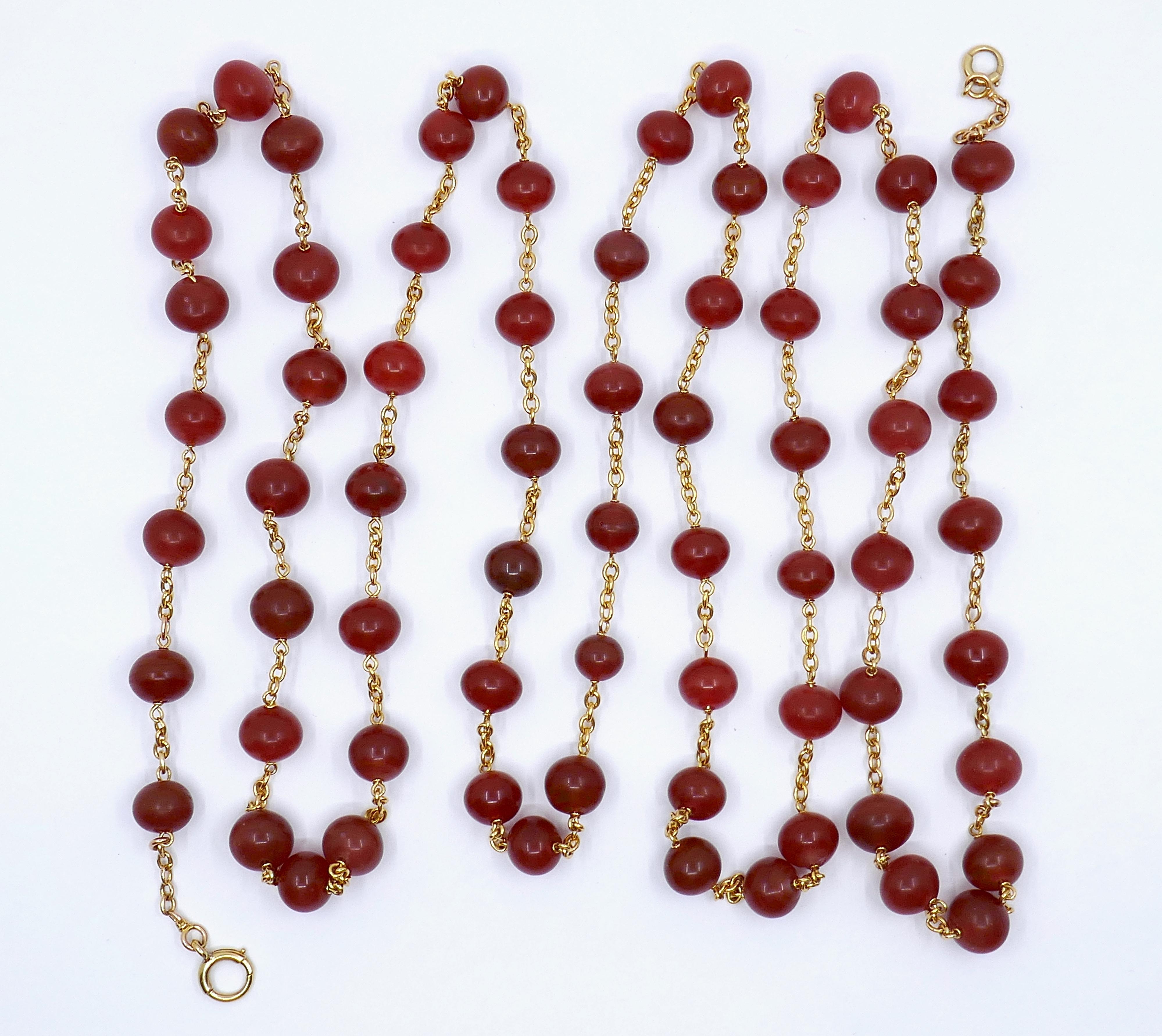 This Carnelian Gemstone Beaded 18k Gold Chain Necklace is a striking and versatile accessory that radiates warmth and sophistication. The rich, fiery hues of the carnelian gemstone beads, which vary in color and shape, are beautifully complemented
