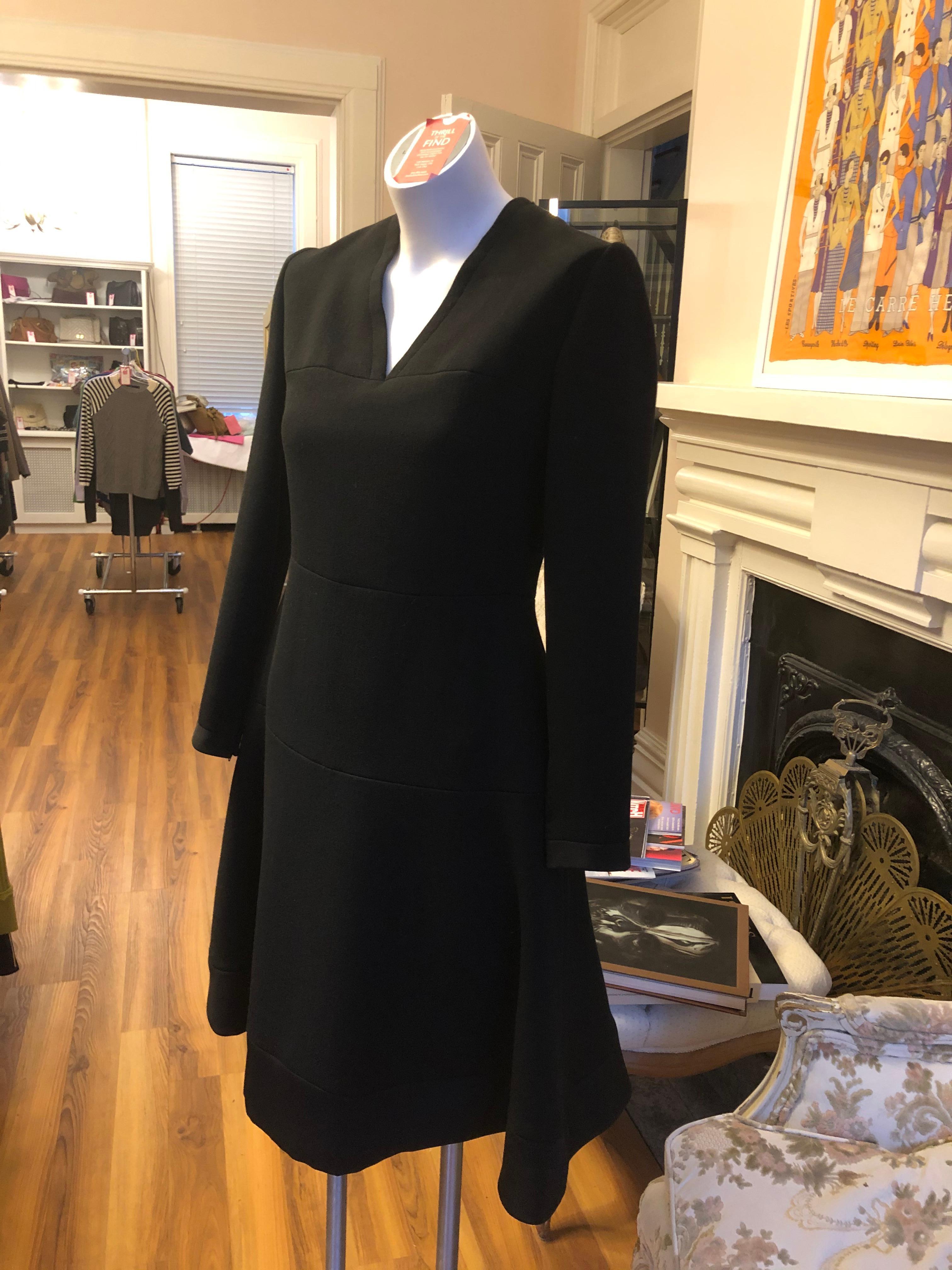 This demi-couture dress was created by the Rome atelier started by Princess Giovanna Caracciolo Ginetti and her friend Angelini Desalles, in 1947. It is a well made and executed dress of heavy wool, with zips at the cuffs; a v-neck collar, a full