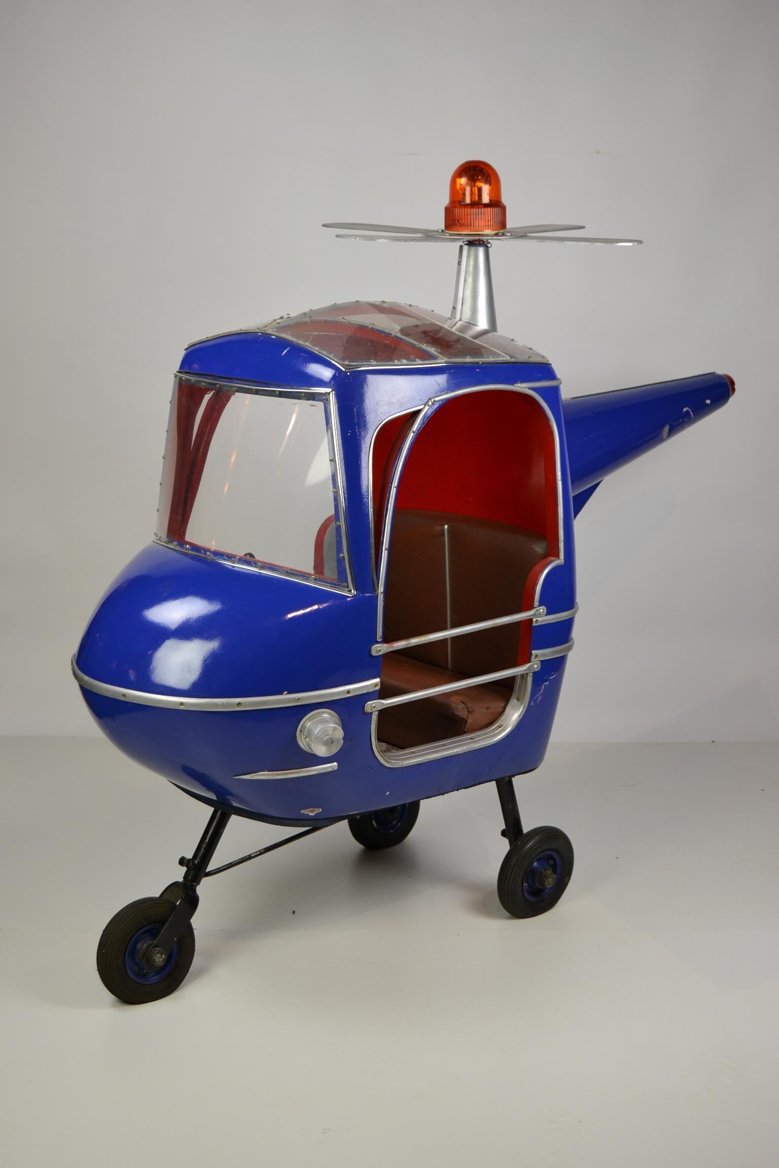 Eye-catching Blue carousel ride chopper.
This Carnival Art Helicopter was made by the German Company Hennecke during the 1950s.
Its a carnival ride for 2 kids with 2 steering wheels inside.
This whirlybird has the color bright blue - cobalt