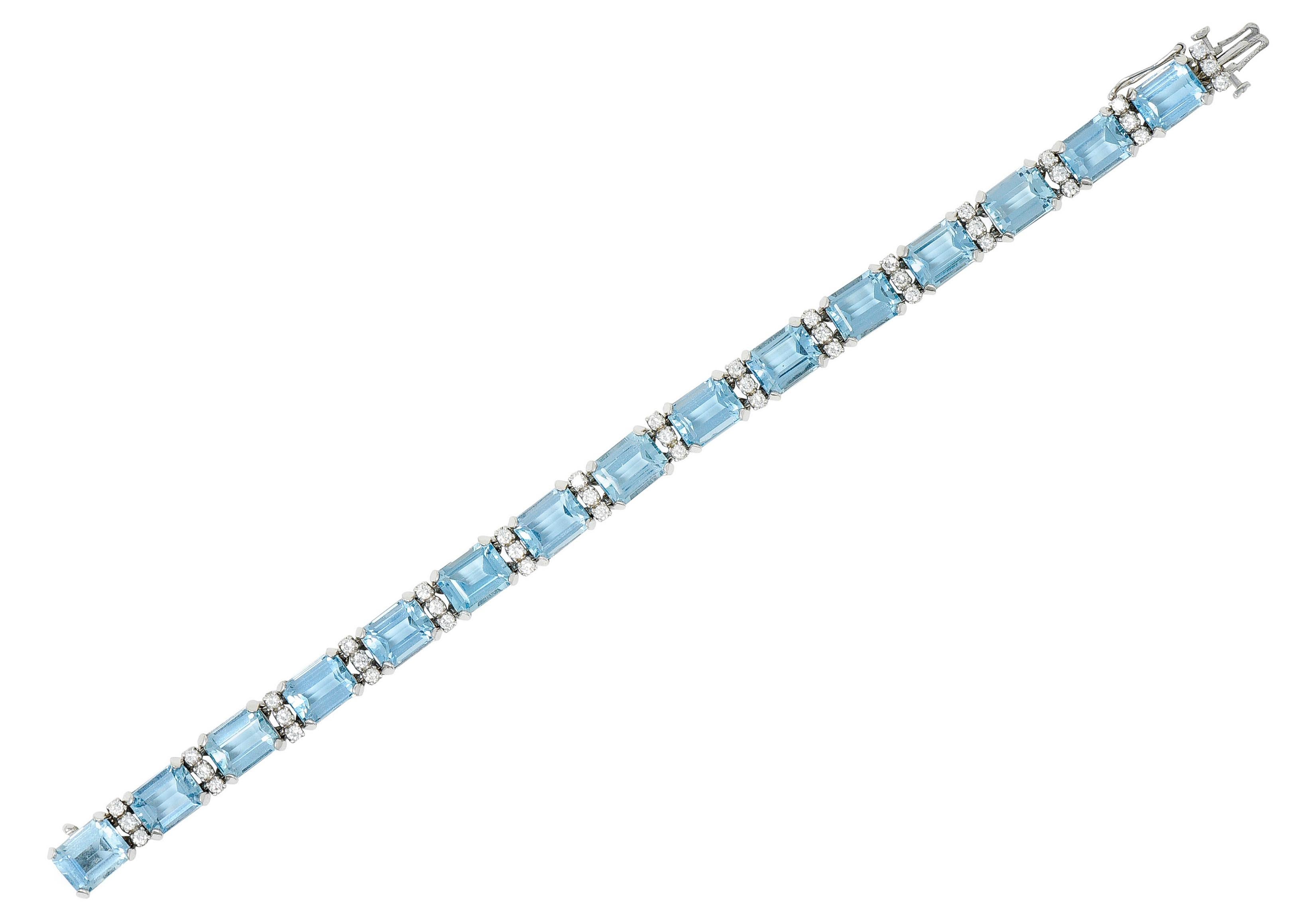 Link bracelet is comprised of emerald cut aquamarines weighing in total approximately 32.00 carats

Extremely eye clean with medium light greenish blue color - very well matched

Set by wide prongs and alternating with diamond spacer links

Round