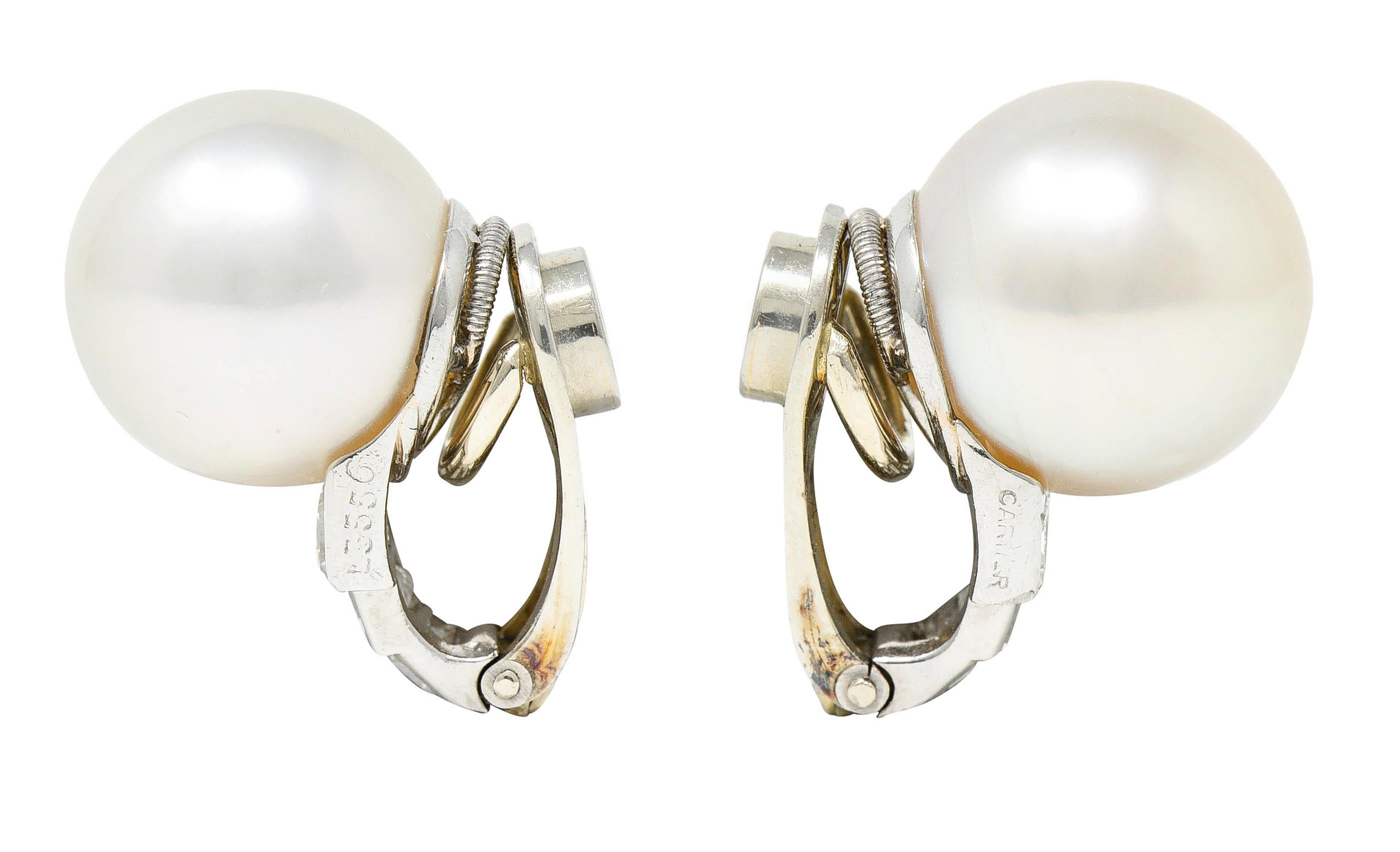 Featuring 11.5 mm South Sea pearls - one with white body color while other is cream

Both with moderate iridescence and excellent luster

Earring slightly curves at base and is bezel set with rectangular step cut diamonds

Weighing in total