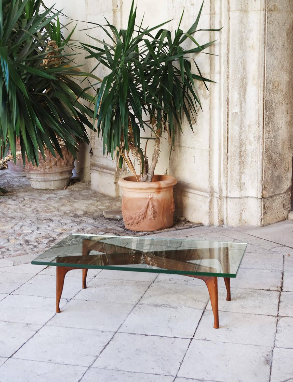 A beautiful wooden and thick glass Italian coffee table attributed to Fontana Arte. While we cannot validate the provenance of this piece, it is nevertheless an exceptional coffee table. The glass is extremely heavy and takes at least two strong