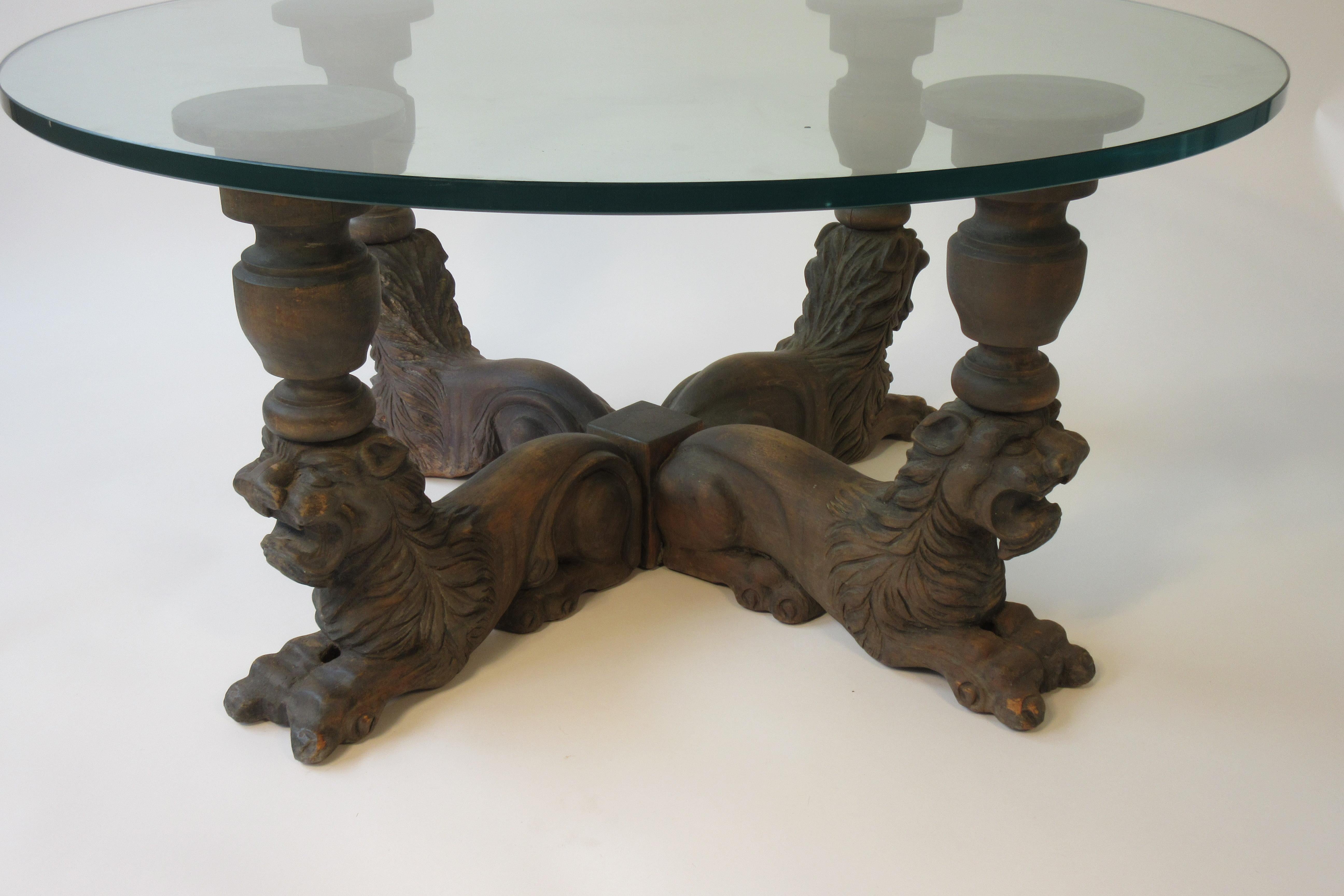 1950s carved wood lion coffee table with glass top. Out of a NYC penthouse apartment.