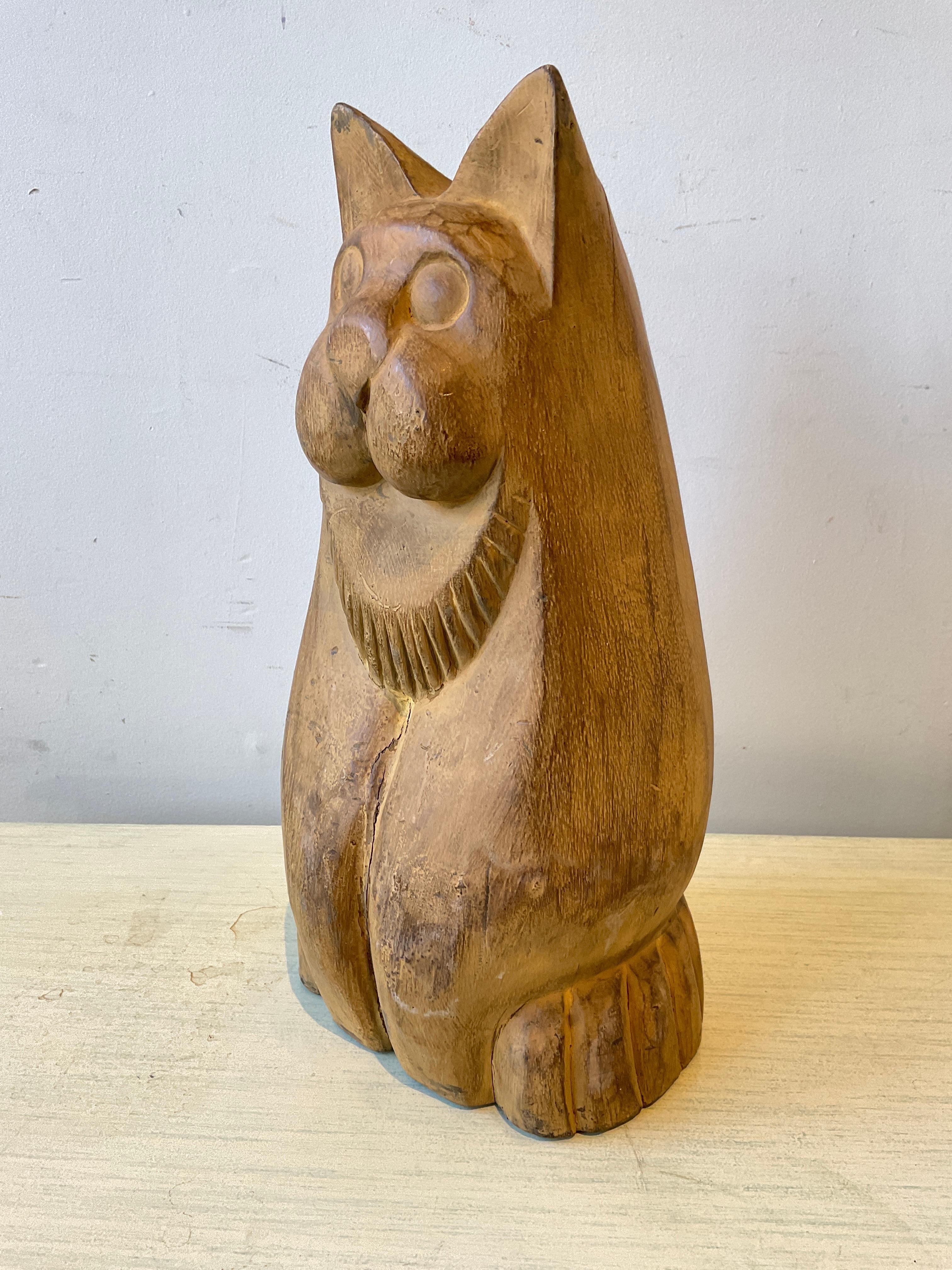 1950sCarved wood cat sculpture. Crack in wood in front.