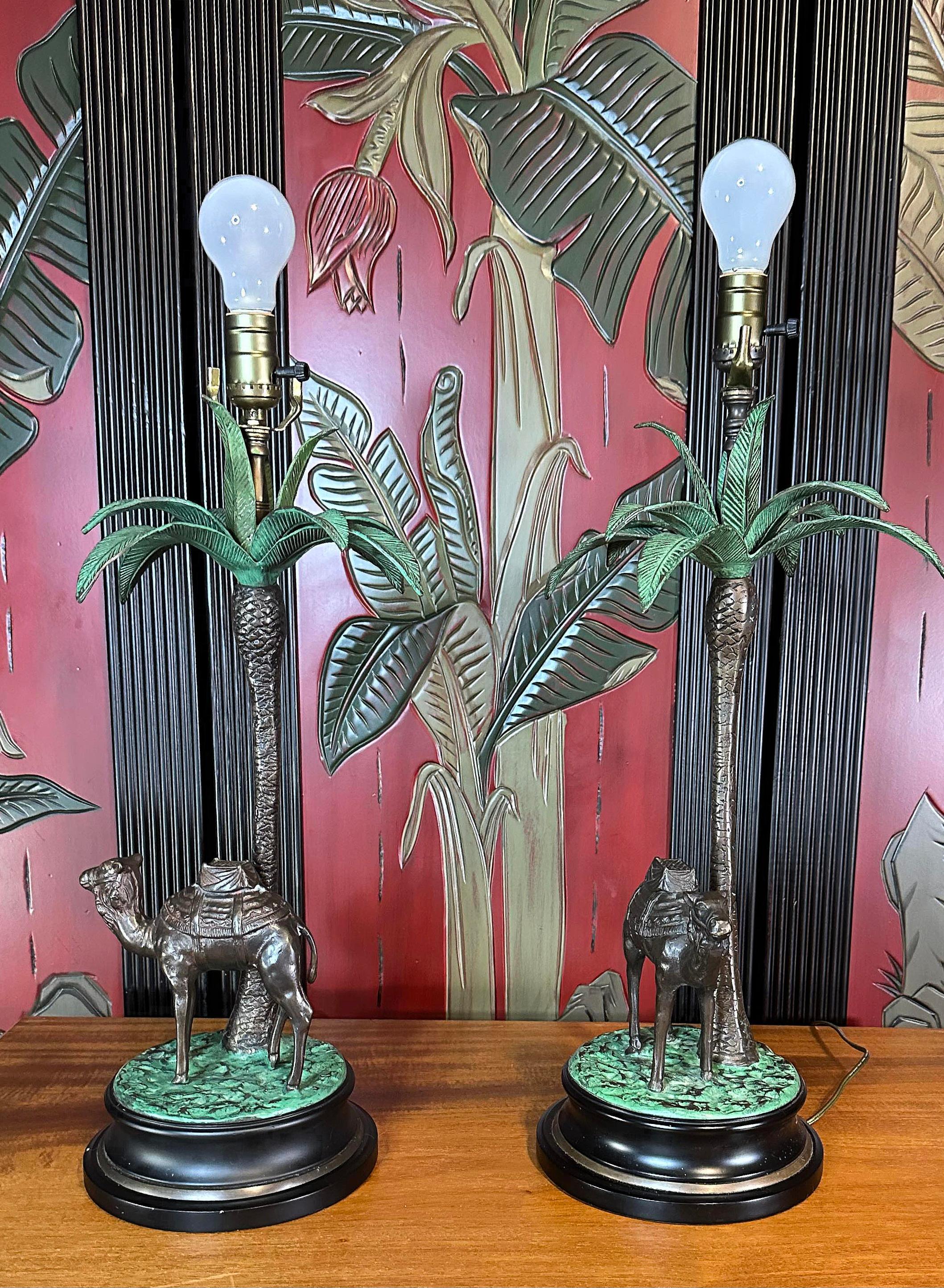 Free shipping in the continental United States. 

Mid century camel and palm tree table lamps, a pair.
Each Camel posed under a palm tree. 
Reminiscent of Earnest Hemingway, Maitland Smith and Tommy Bahama.
Would be at home in Indiana Jones'
