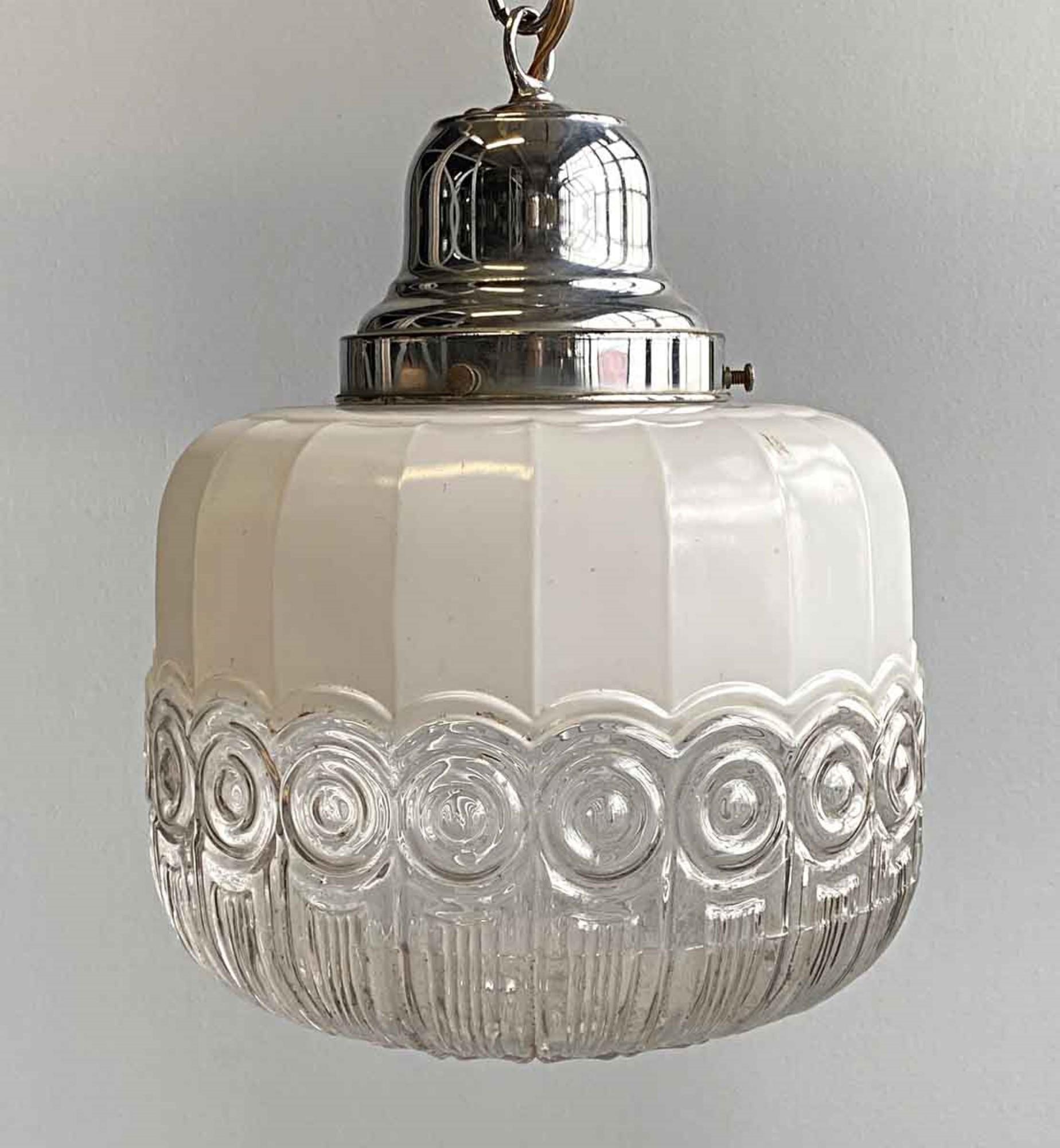 1950s cast glass white and clear globe with unuual swirl detail featuring polished nickel hardware. This can be seen at our 400 Gilligan St location in Scranton. PA.