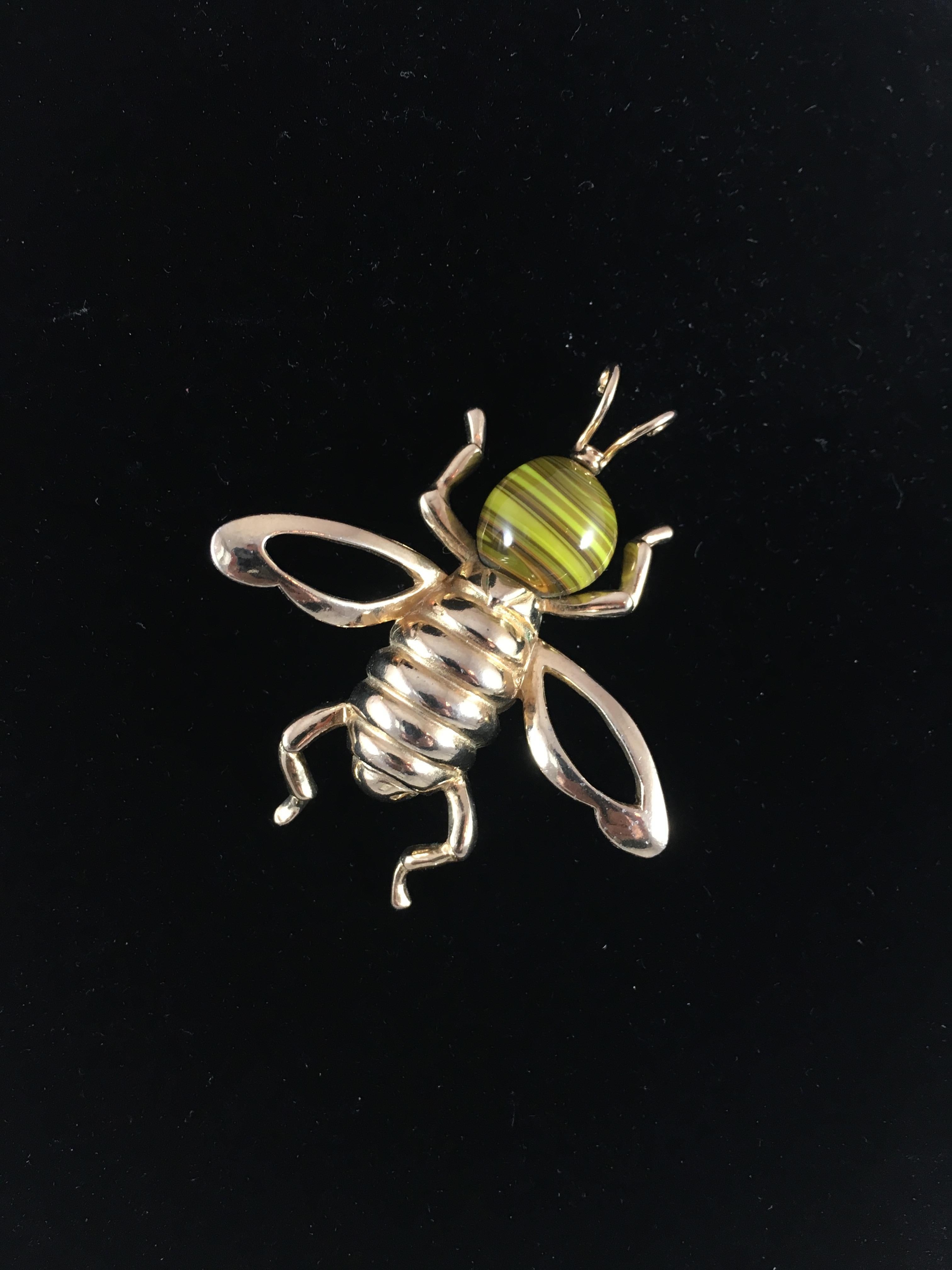 This is an adorable bee brooch made by Castlecliff in the 1950s. It has a gold-tone body and a head made out of striated yellow art glass. It measures 2 1/4 inches long x 2 inches at its widest point and is marked 'Castlecliff' on the back of the