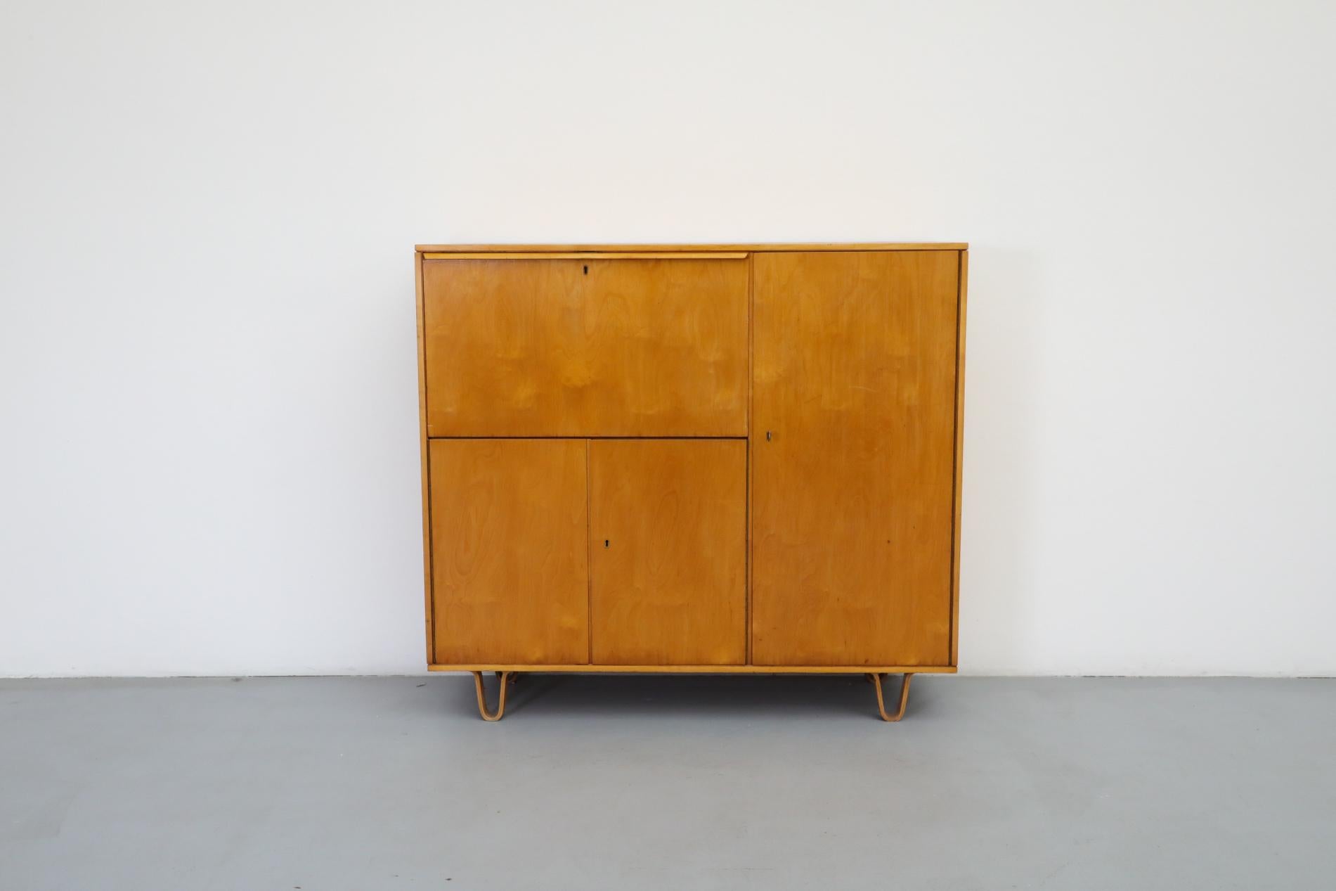 Beautiful, lightly refinished Cees Braakman “Combex Series” birch secretaire for Pastoe with bent wood feet. The drop down desk has a shelf and little cubbies. The tall right side cabinet has shelving and 2 signature Cees Braakman drawers with