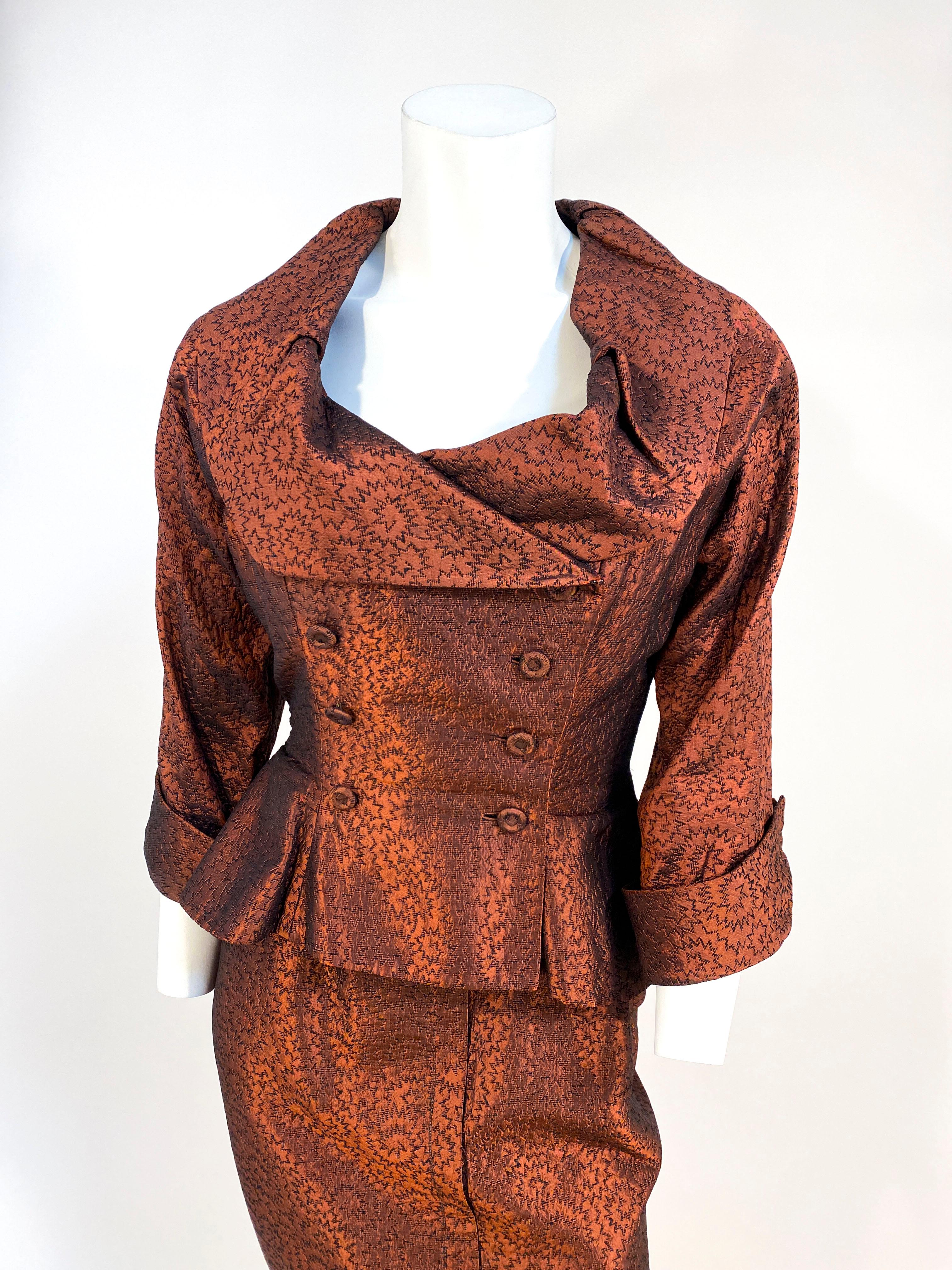1950s Ceil Chapman metallic rust-colored Cocktail Suit made of an atomic-patterned silk brocade. The Dress has spaghetti straps, a fitted torso, pipped was it line, side metal zip closure, faux kick pleat, and a hook & eye strap. The jacket is