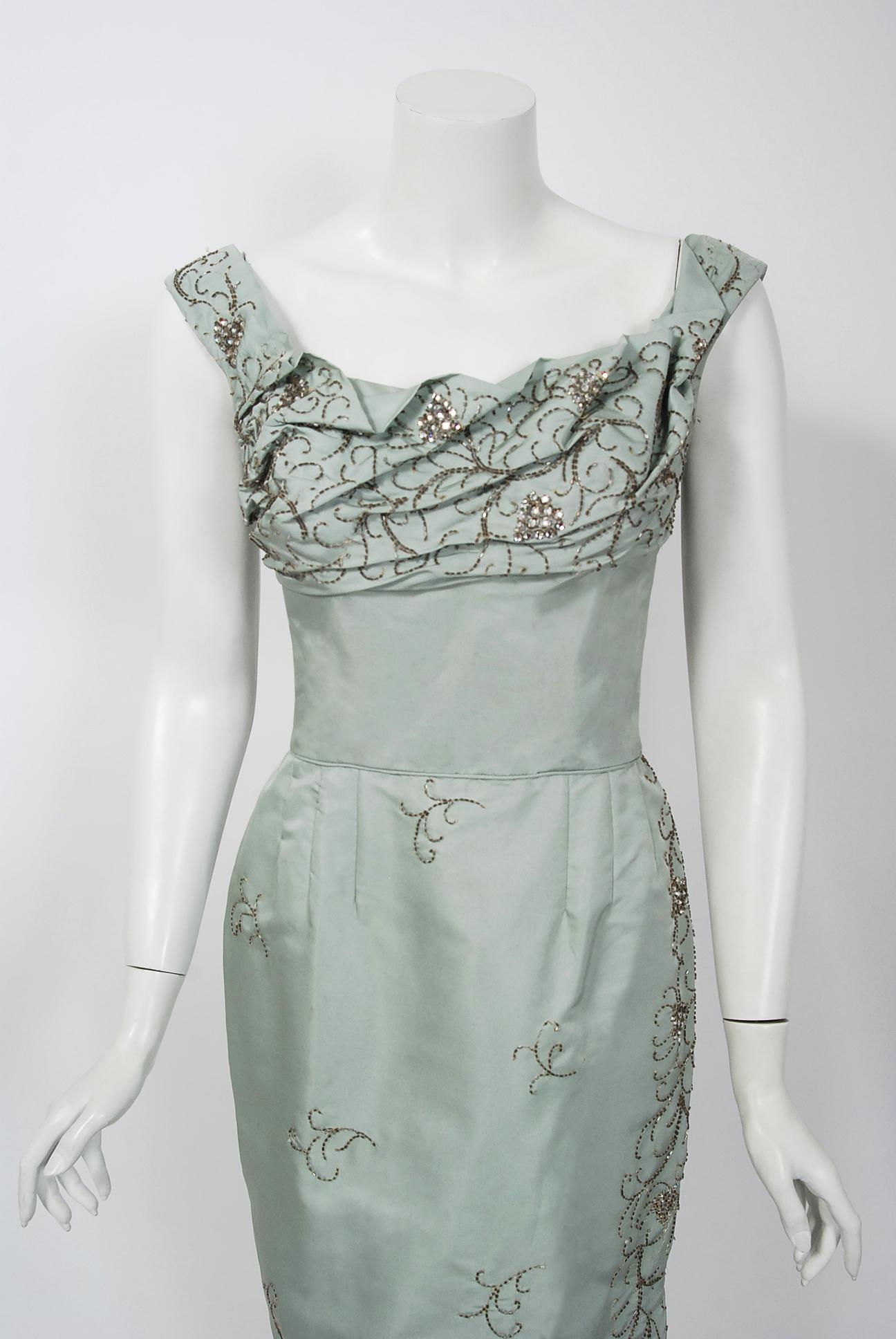 This is such a breathtaking cocktail dress from the iconic Ceil Chapman designer label. Perfect for any upcoming special event; you can't help but feel feminine in this beauty. The garment is fashioned from stunning mid-weight baby-blue lined silk.