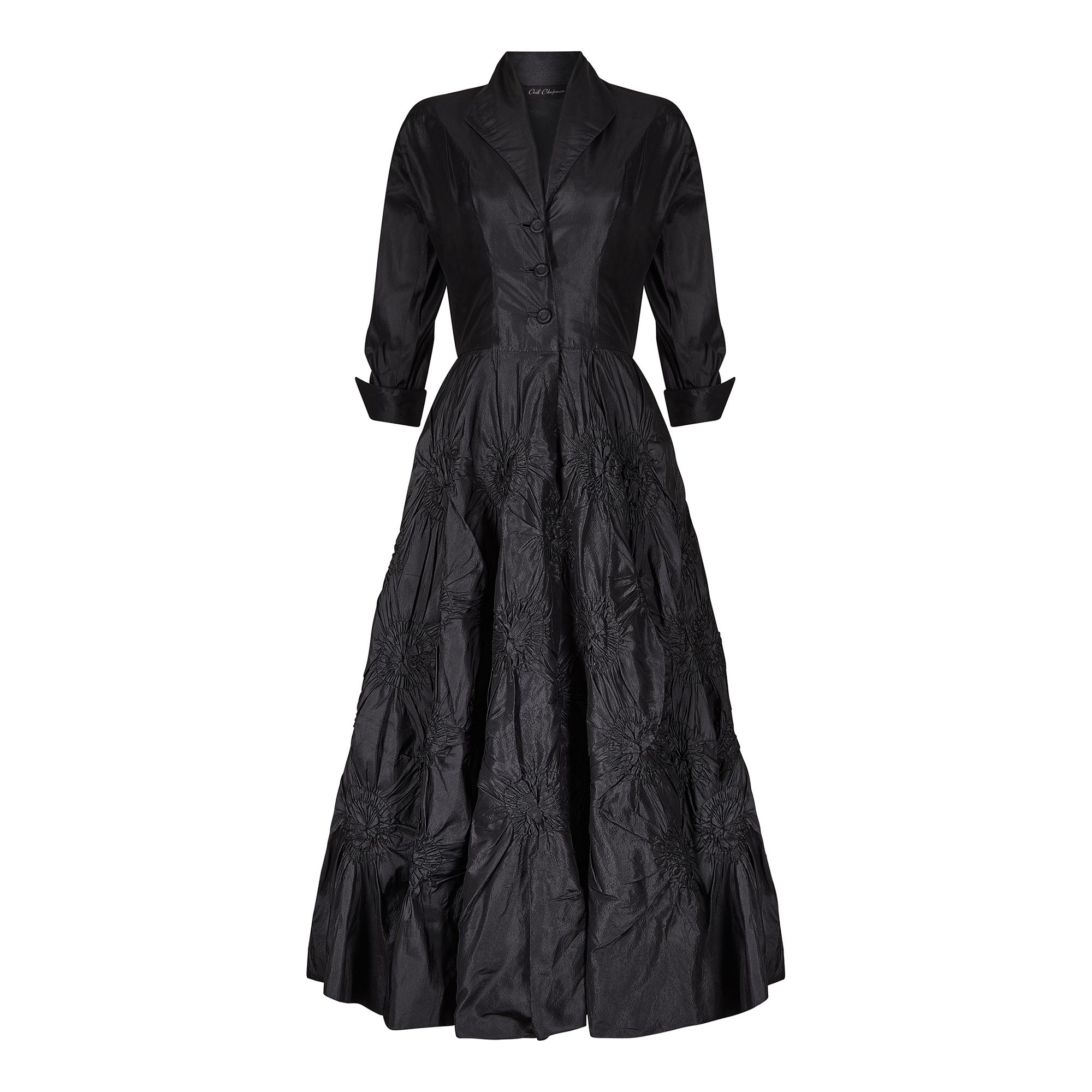 This is a brilliant example of Ceil Chapman's early work from the late 1940s to early 1950s and the black taffeta silk design is exquisite. Its the first thing you notice about this dress which has the most unusual construction. The skirt's textured