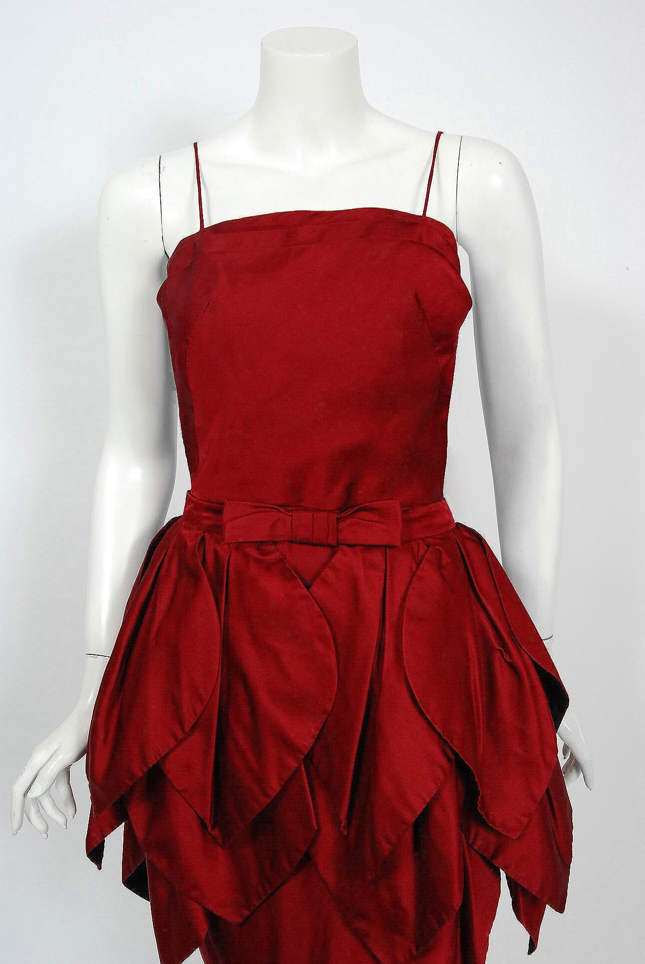 This is such a breathtaking 1950's couture party dress from the iconic Ceil Chapman designer label. Perfect for Valentine's Day; you can't help but feel sensational in this beauty. The garment is fashioned from stunning mid-weight silk in the