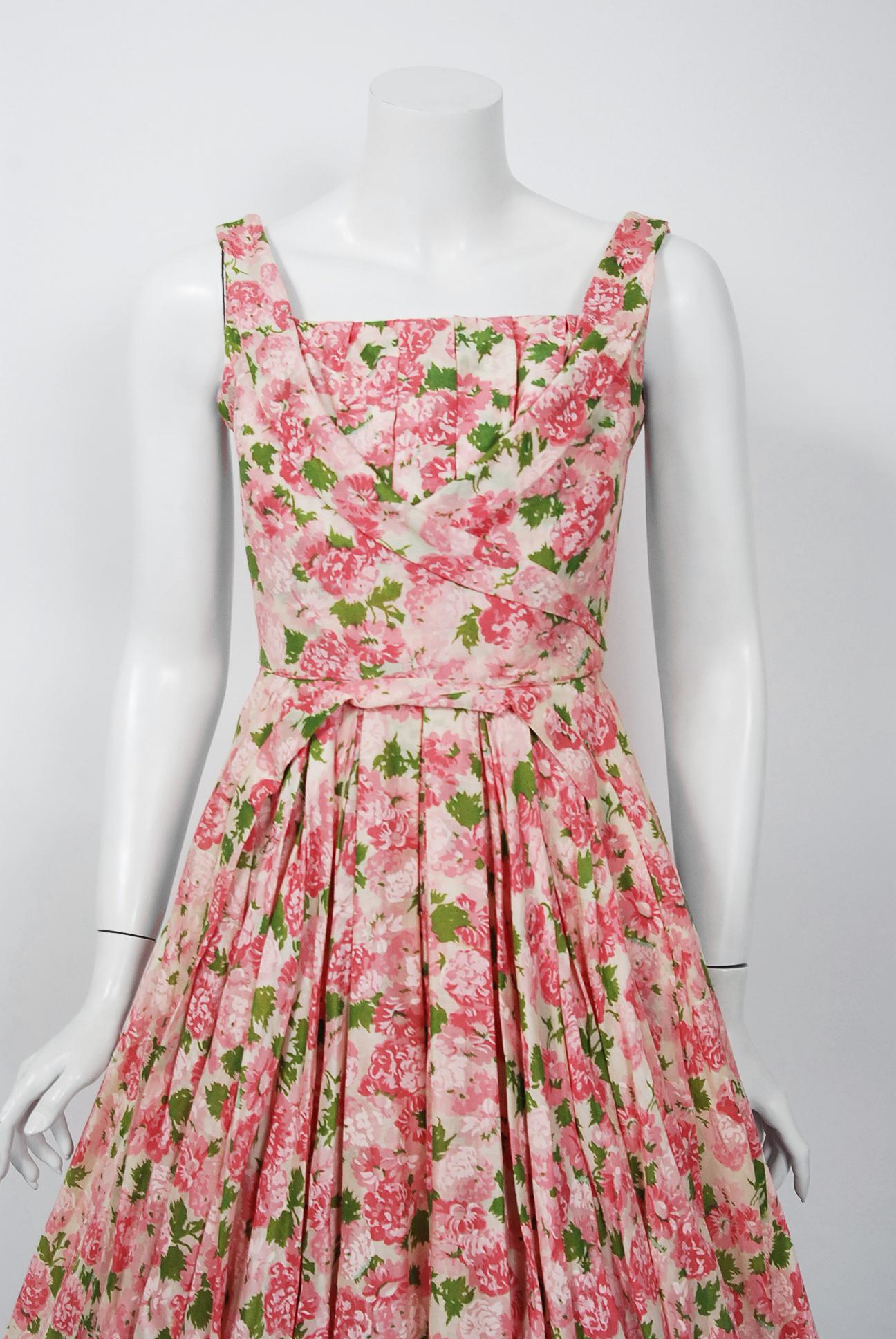 This is such a romantic and elegant 1950's sundress from the iconic Ceil Chapman designer label. Perfect for any spring or summer party; you can't help but feel feminine in this beauty. The garment is fashioned from a pink carnation floral print