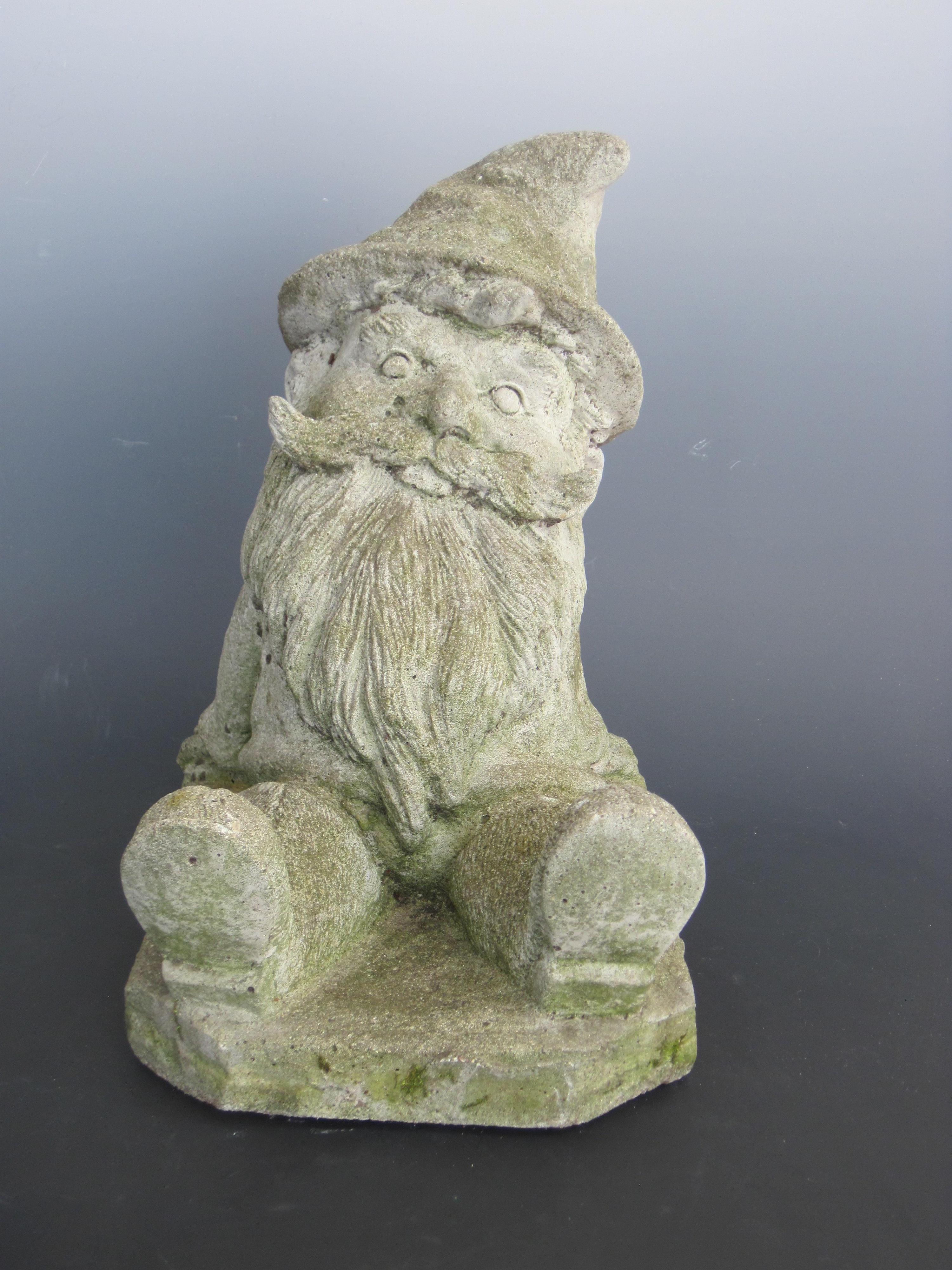 Heavy cement garden gnome statue leaning back in a relaxed pose with a wide mustache, long beard wearing his hat and boots. Moss included... garden ready. c.1950s