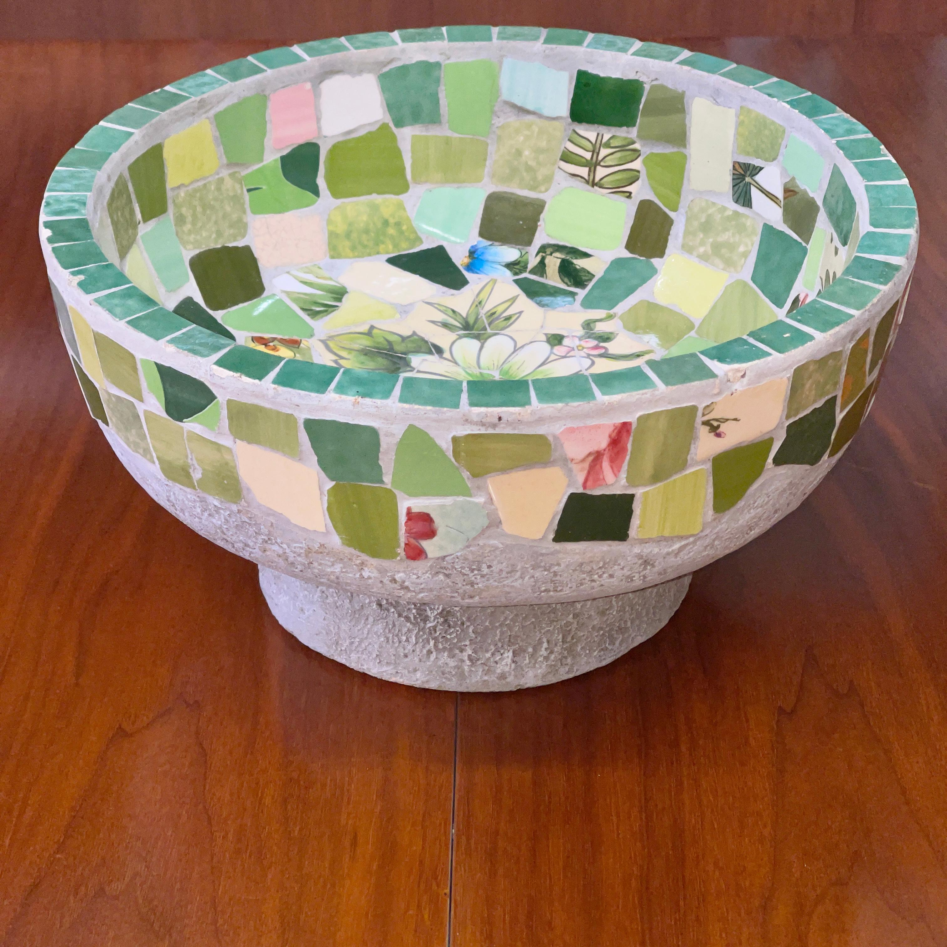 1950's California craft made cement and tile garden vase or footed bowl. Nice mixture of ceramic and glass mosaic tiles. Unsigned. 12 inches diameter, 6.5 inches high. Quite heavy. Would make a beautiful centerpiece or vide poche.