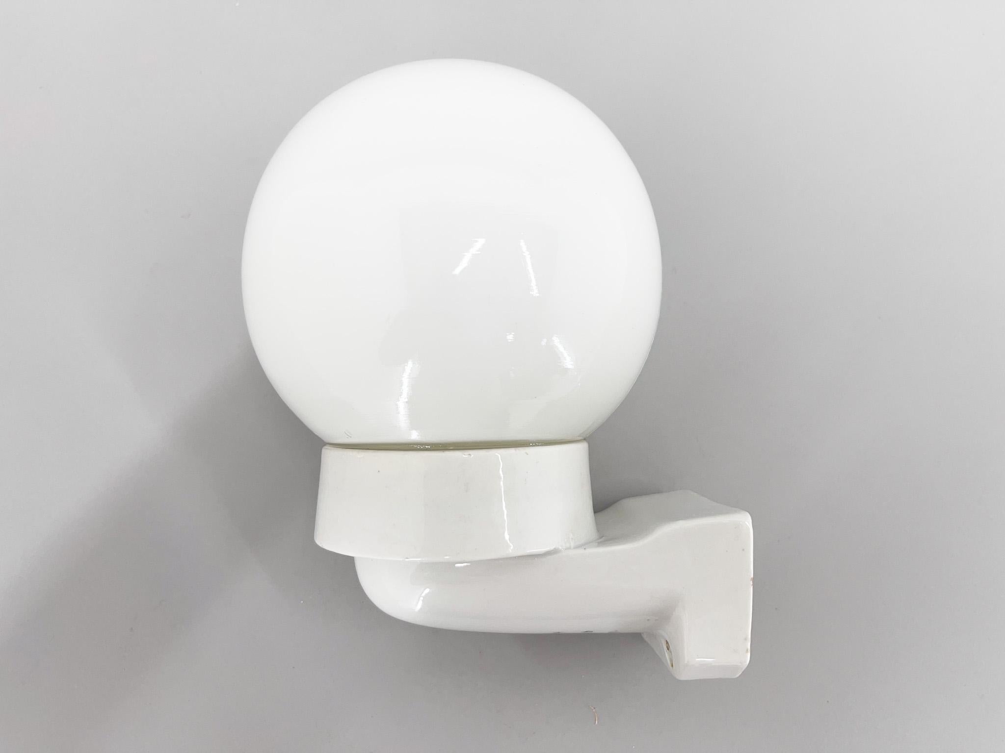 Mid-century wall light made of ceramic base and opaline glass shade. New wiring.
