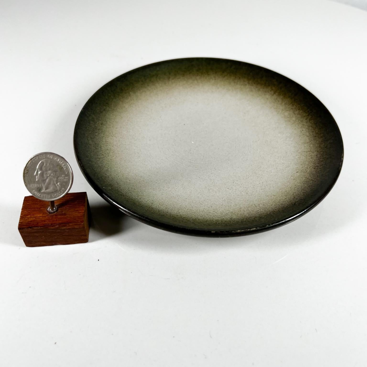 1950s Modern Pottery Stoneware Handcrafted by designer Edith Heath Ceramics California
Small Green Plate. Sea and Sand Coupe shaped plate. Lovely pattern.
Beautiful matte finish and coloring that starts as dark green on the edge and fades to sand