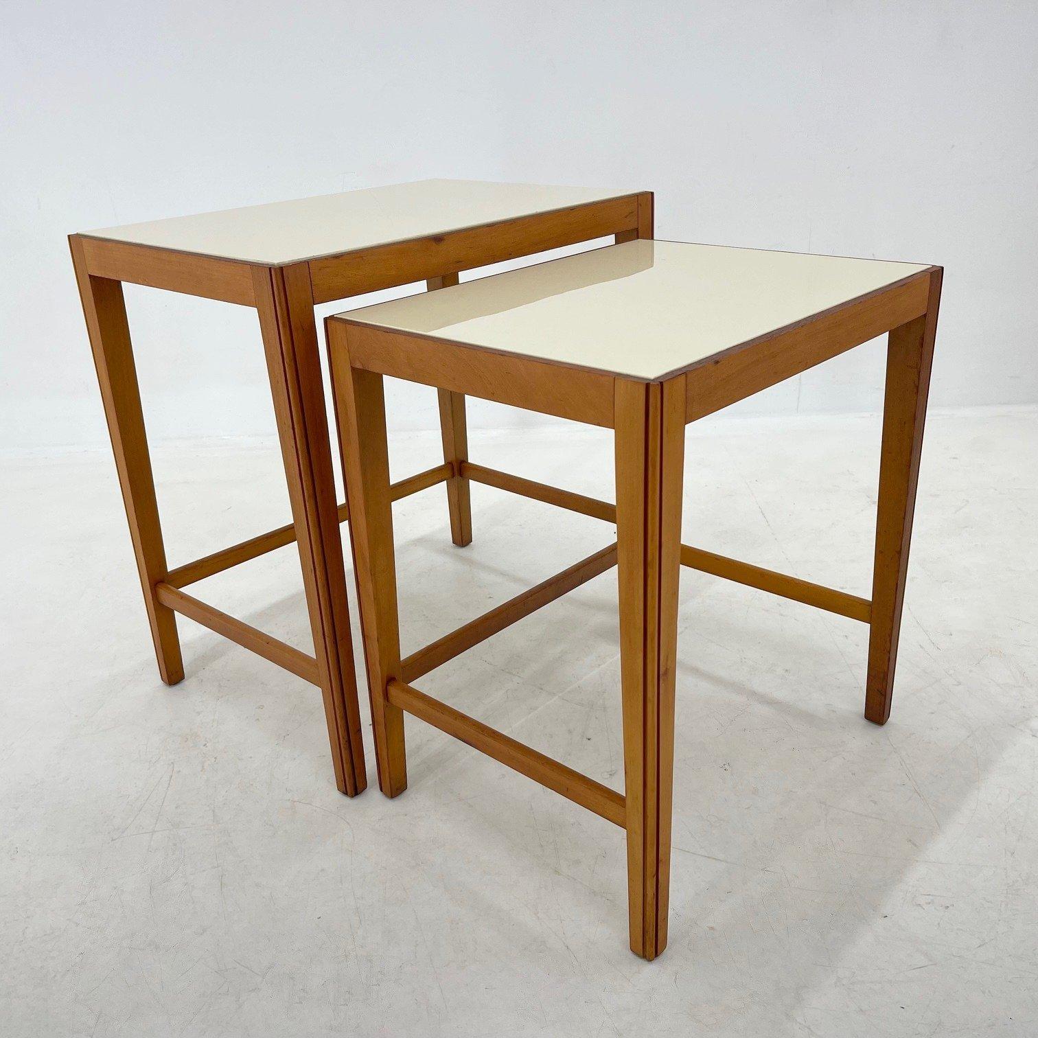 Set of two nesting tables. The top is made of ceramic, wooden parts were carefully refurbished.