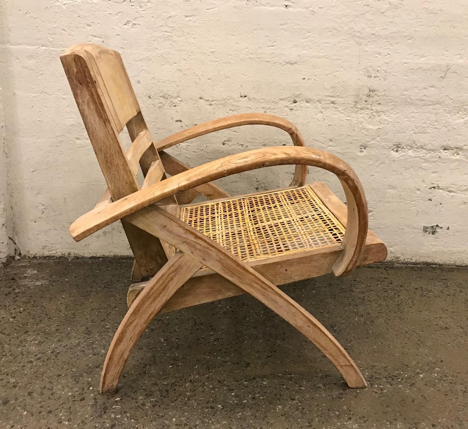 1950s cerused lounge chair attributed to Rene Gabriel. Has a collapsible back, a caned seat and curved arms.