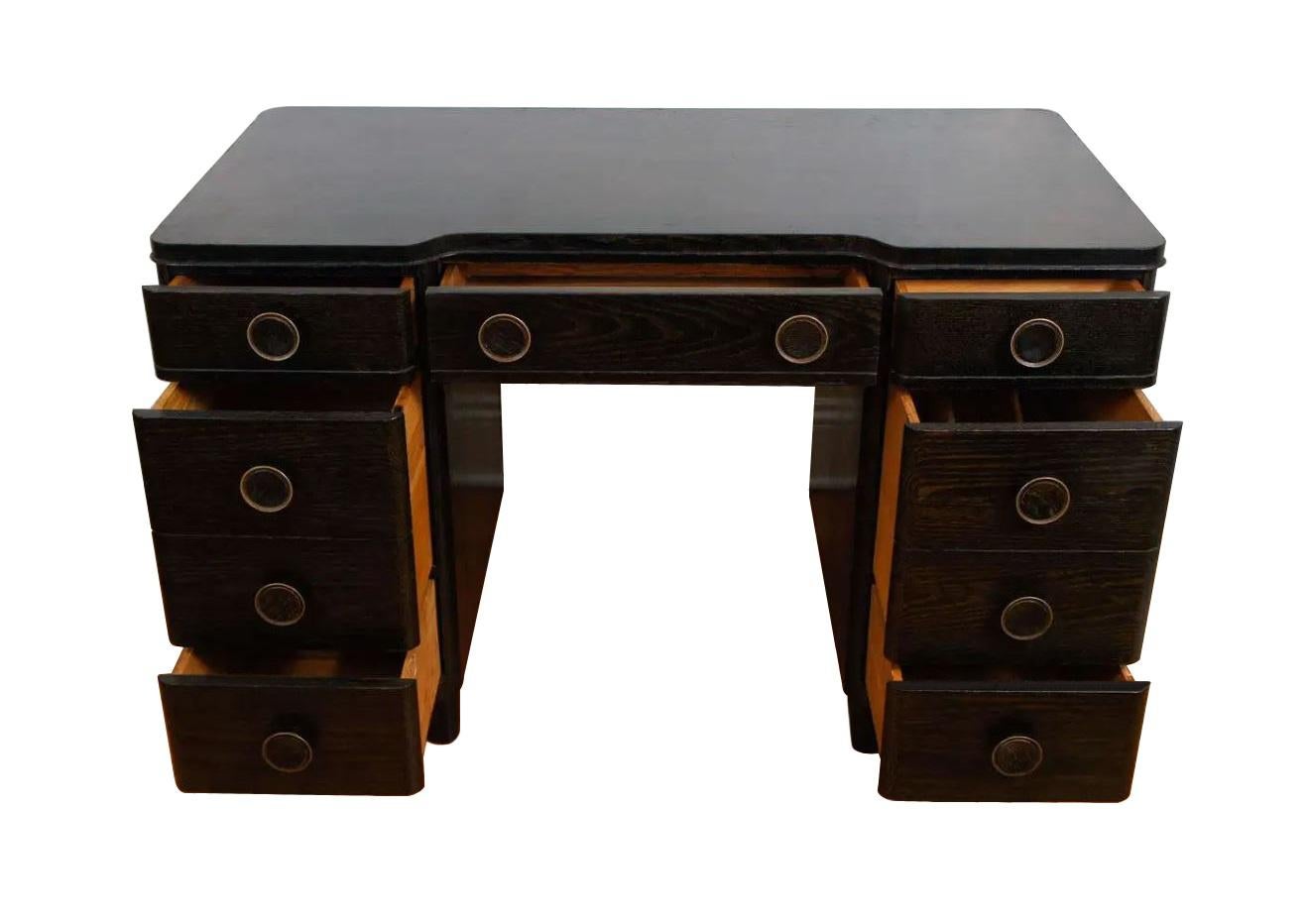 A very well crafted oak desk produced by Huntington Chair Corporation. This incredible example of Art Deco design is a collectible piece. Restored to mint condition. The desk has a cerused finish which highlights the nubian oak wood grain. Slightly
