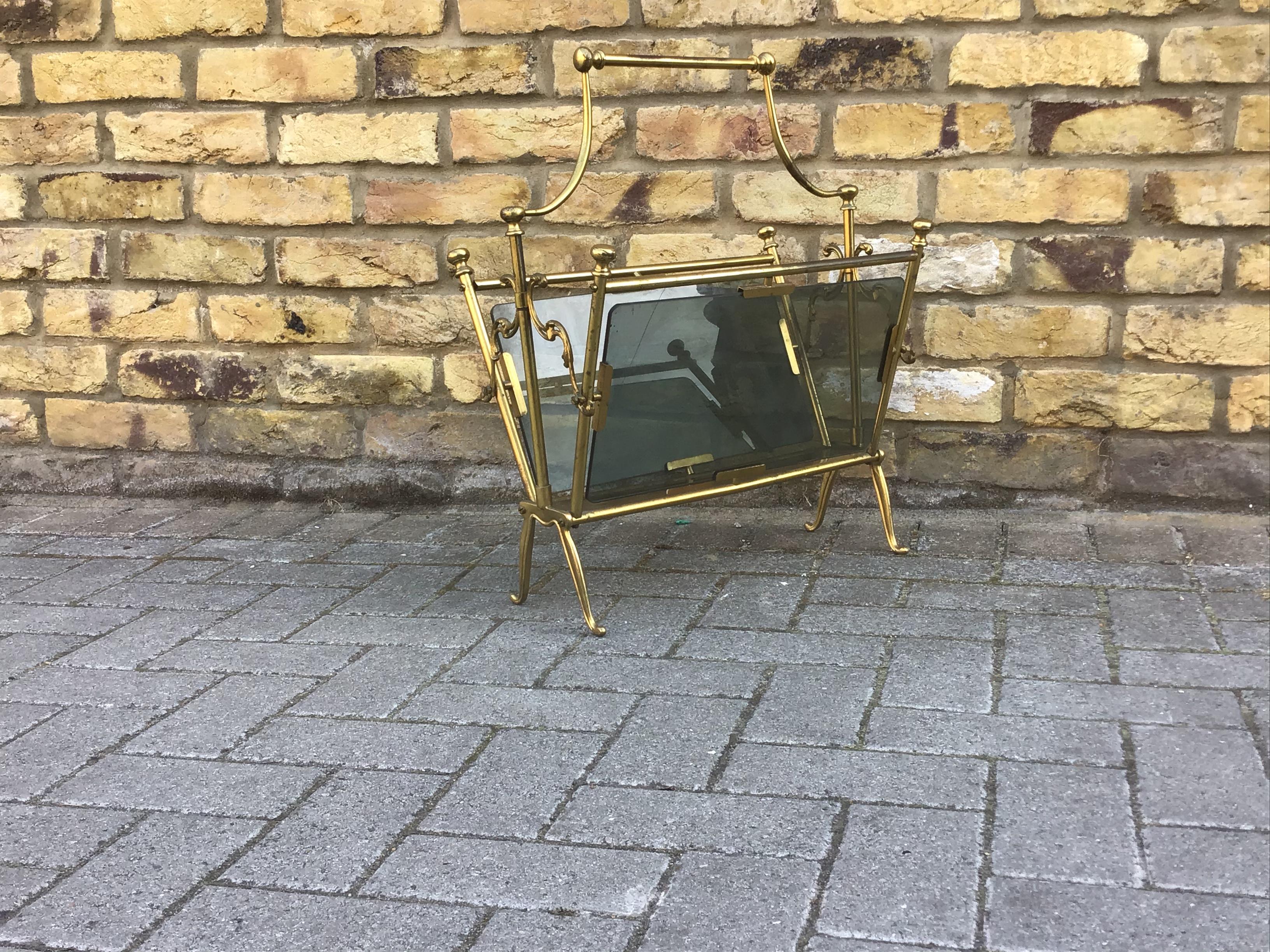 Born Naples in 1972 Italian architect designer Cesare Lacca 
created modernist furniture and metalwork throughout
the 1950s 
This unusual magazine rack is constructed of glass
 and brass.