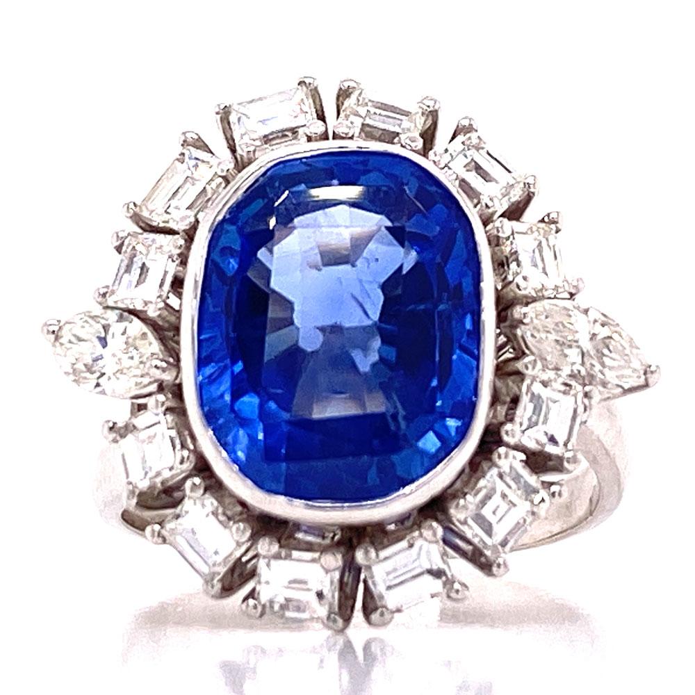 1950's cocktail ring featuring a Blue Ceylon Sapphire that has been certified by the GIA. The oval sapphire has not had any treatment or heat used to enhance the color. The sapphire is approximately 5.5 carats and is surrounded by 12 emerald cut and