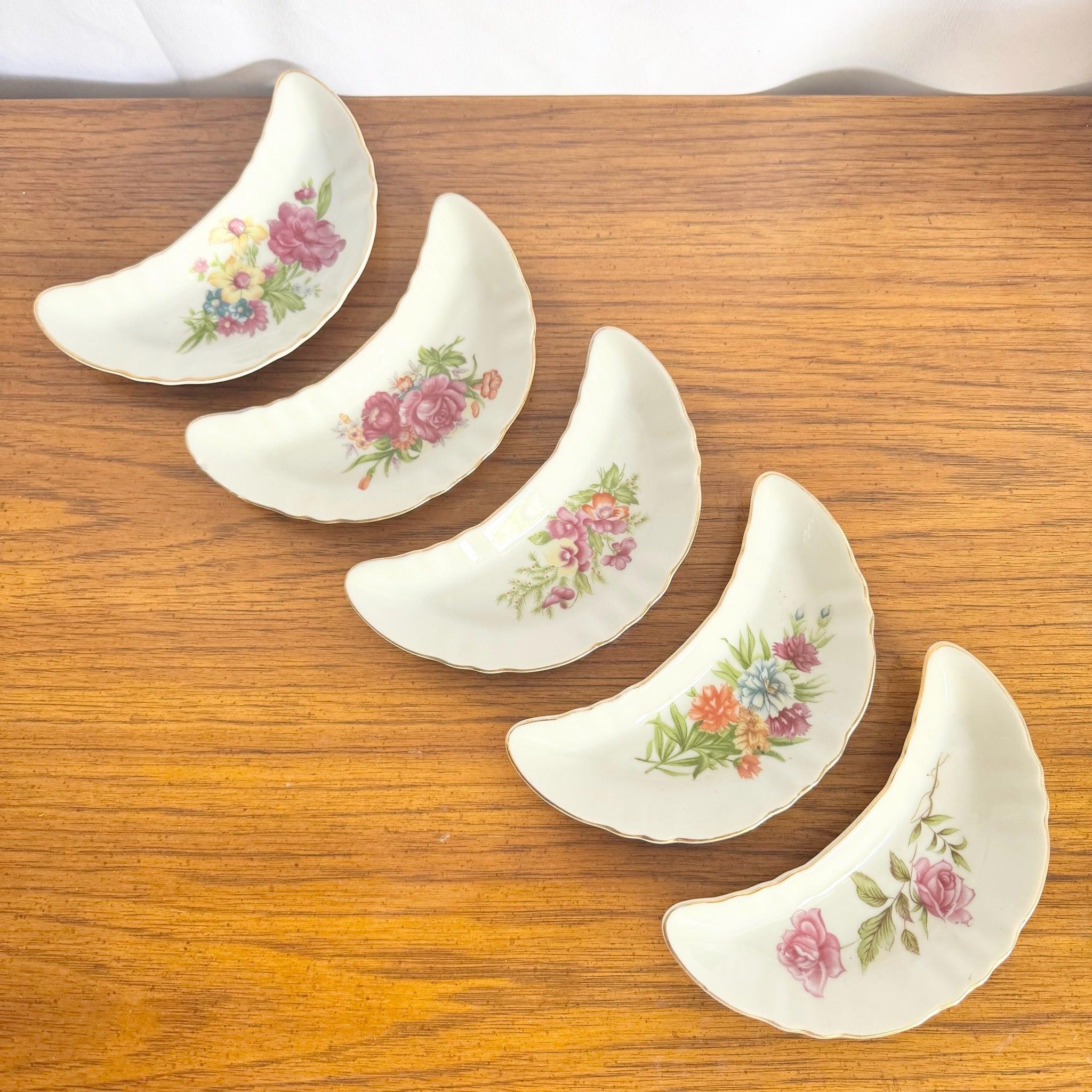 Vintage Chadwick Japan Bone Dish Set of five—crescent bone china with hand-painted florals and gold rims, perfect for elegant tabletop or vanity styling.
 

 We sell items as acquired, without restoring or repairing. Vintage pieces may have