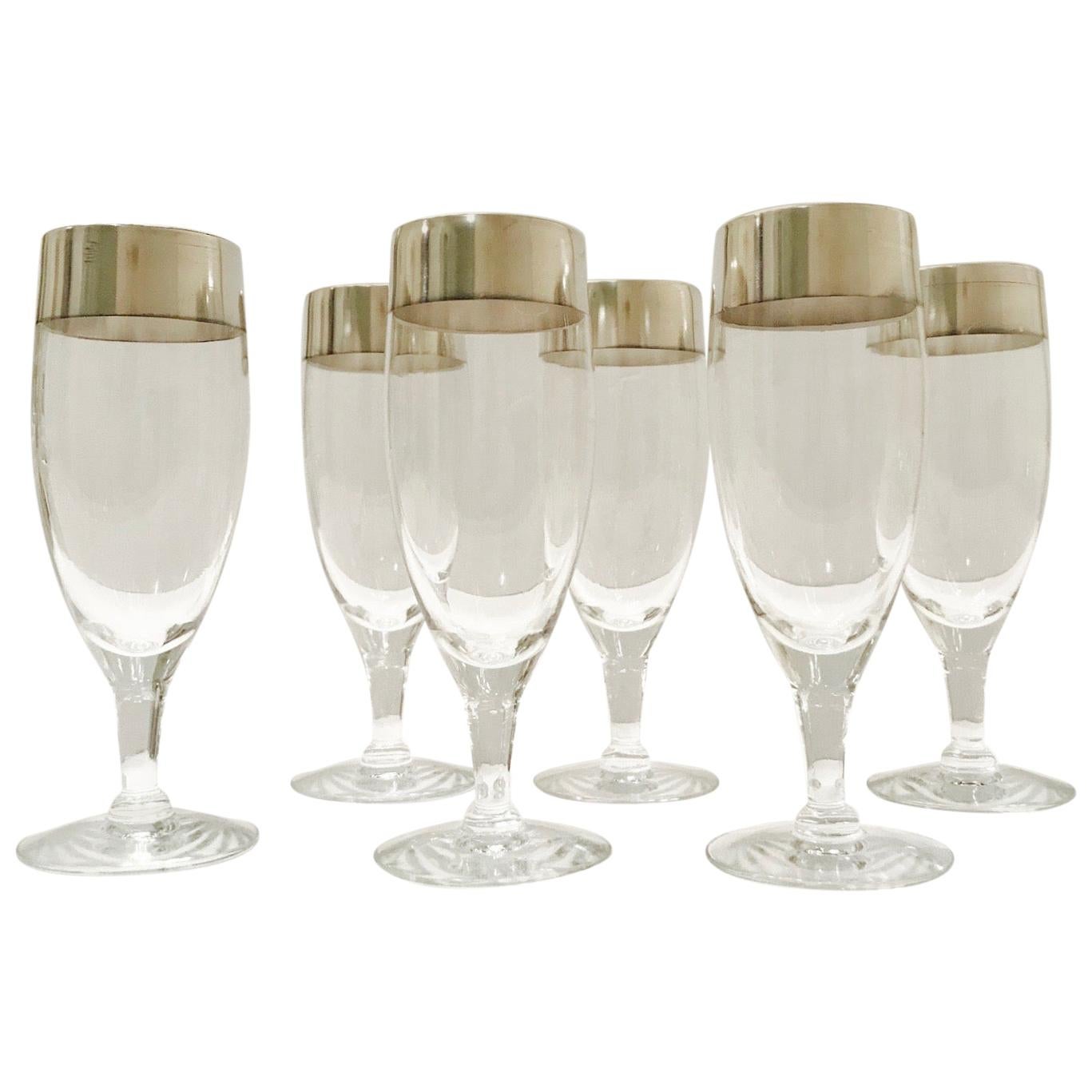 Set of Mid-Century Modern stemware glasses designed by Dorothy Thorpe. The rare blown champagne glasses feature short stems with the iconic sterling silver rims for which Thorpe is recognized and highly sought after. These make an excellent and