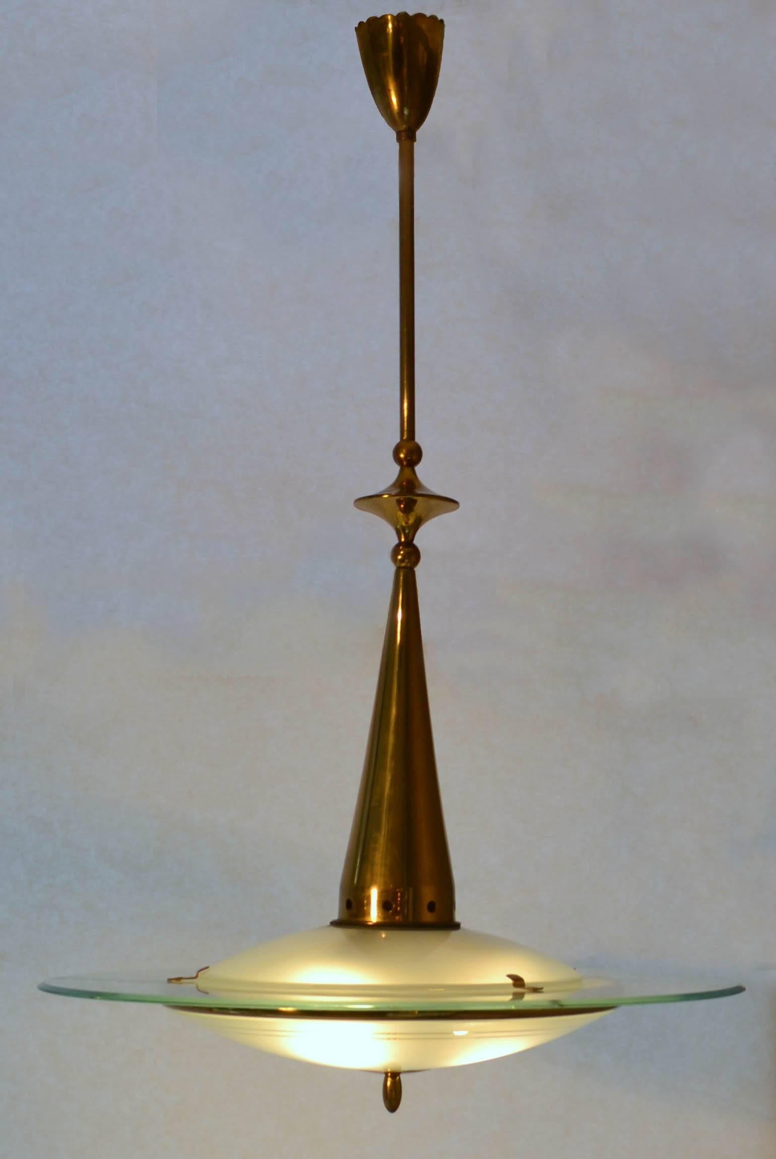 Sophisticated and refined Italian pendant light made of three-pieces of blown and etched glass hold together by brass elements is attributed to Pietro Chiesa, Fontana Arte, Italy, circa 1946-1948
The light is in excellent condition rewired for