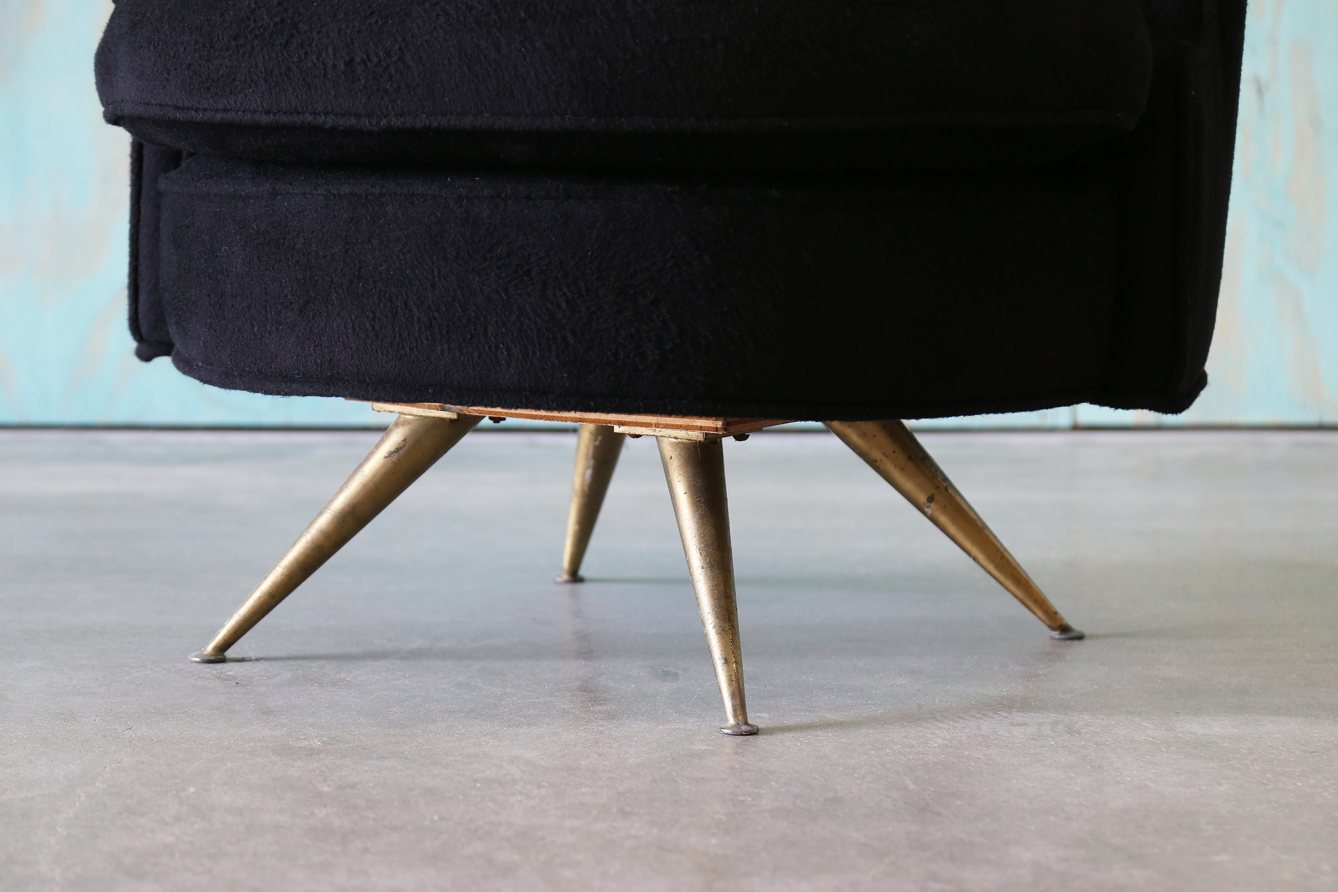 1950s barrel back swivel chair designed by Henry P. Glass for J.G. Furniture. This chair features a beautiful barrel back, accentuated with channel tufting. The even back swoops down to the seat. All floating on tapered brass legs. The chair has a